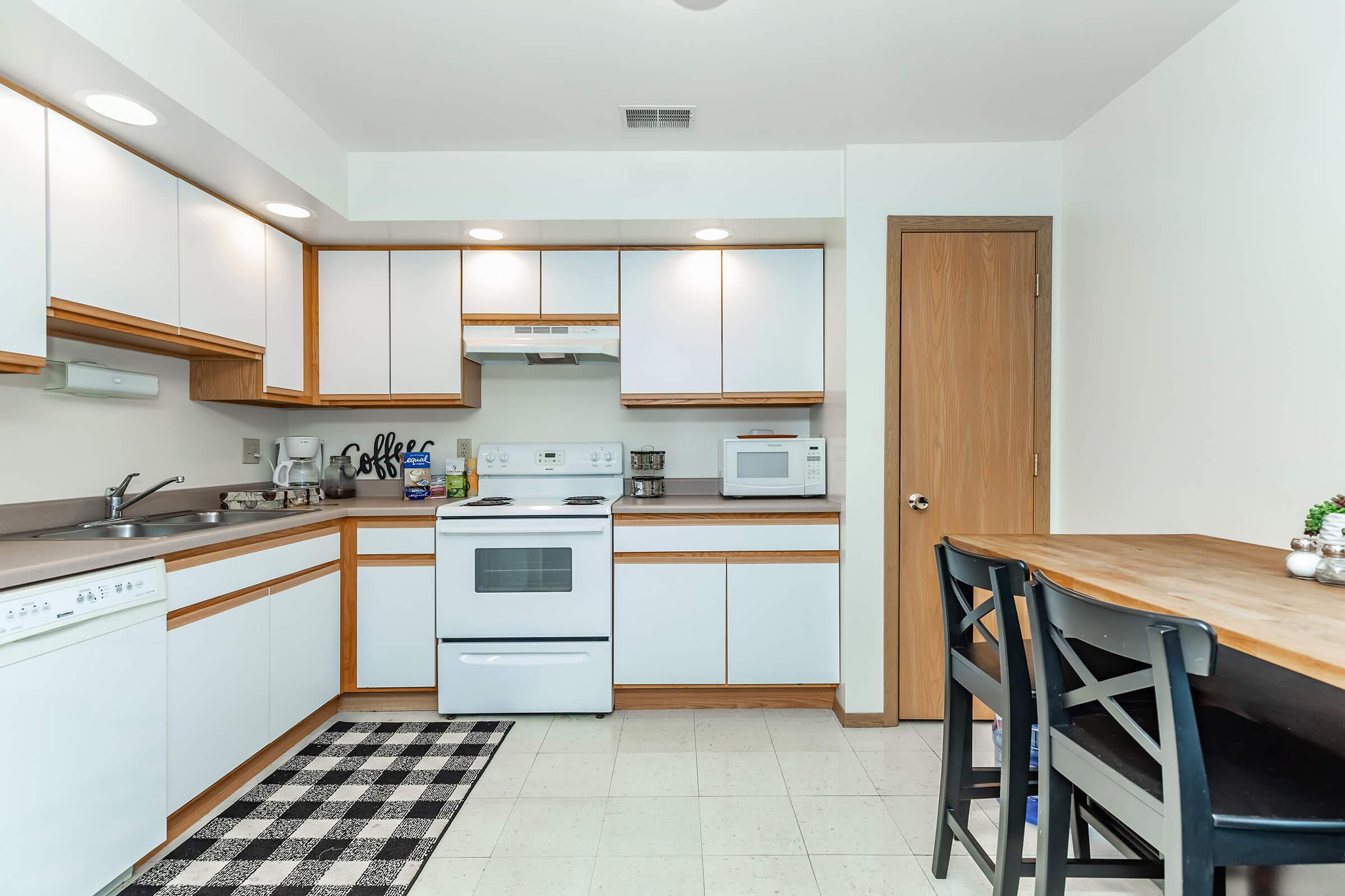 a kitchen with an island in the middle of a room