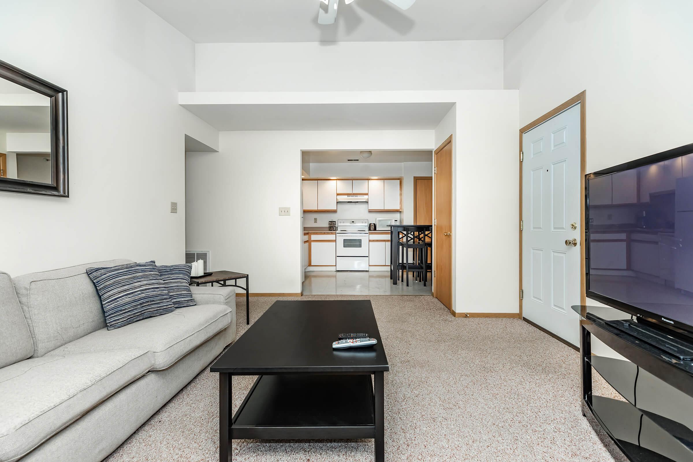 a bedroom with a bed and desk in a room