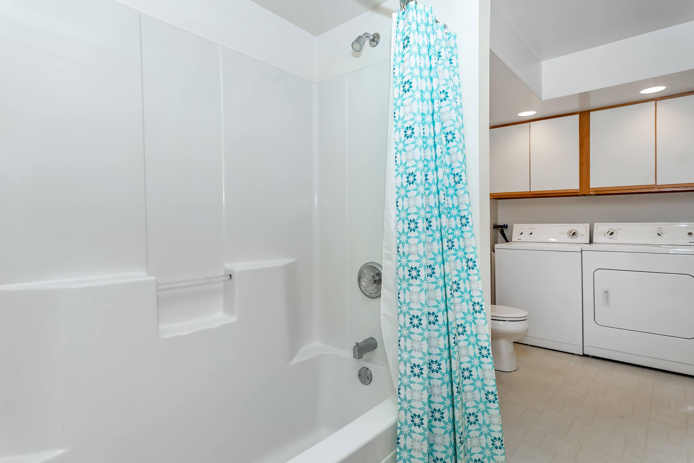 a close up of a white tub sitting next to a shower