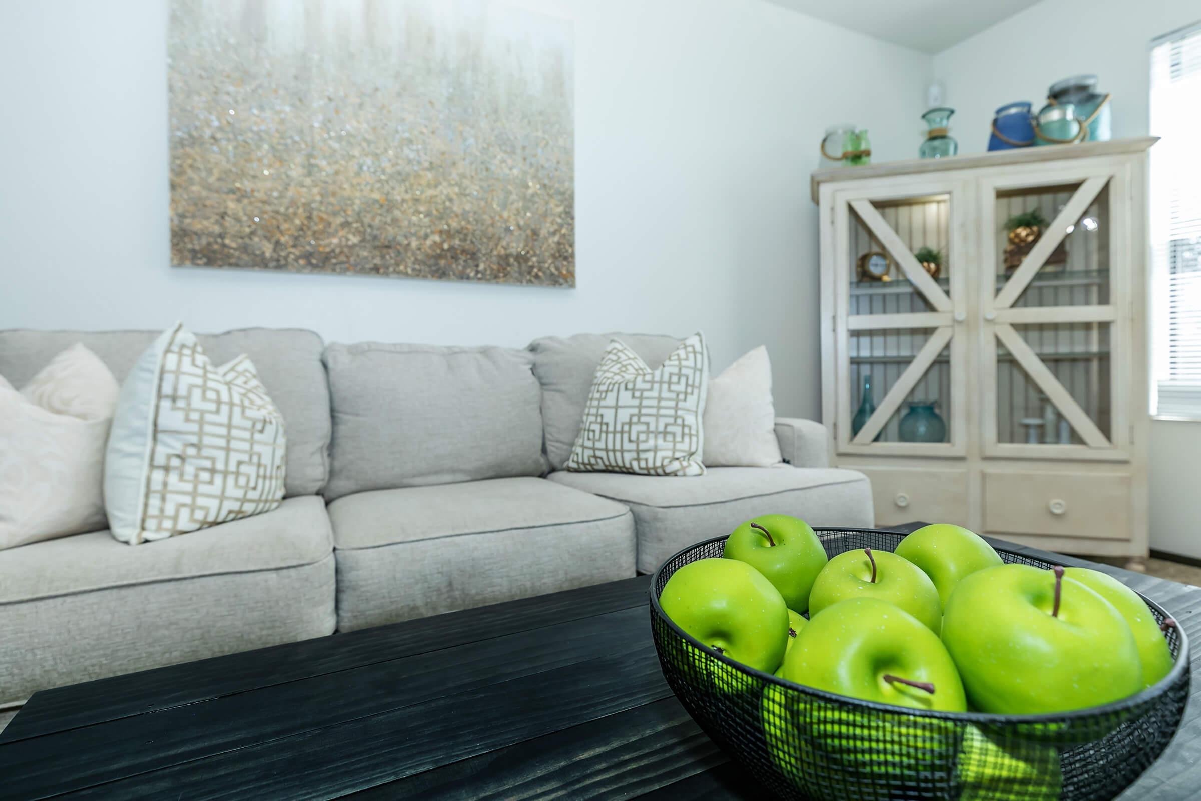 a living room with a green apple on a table