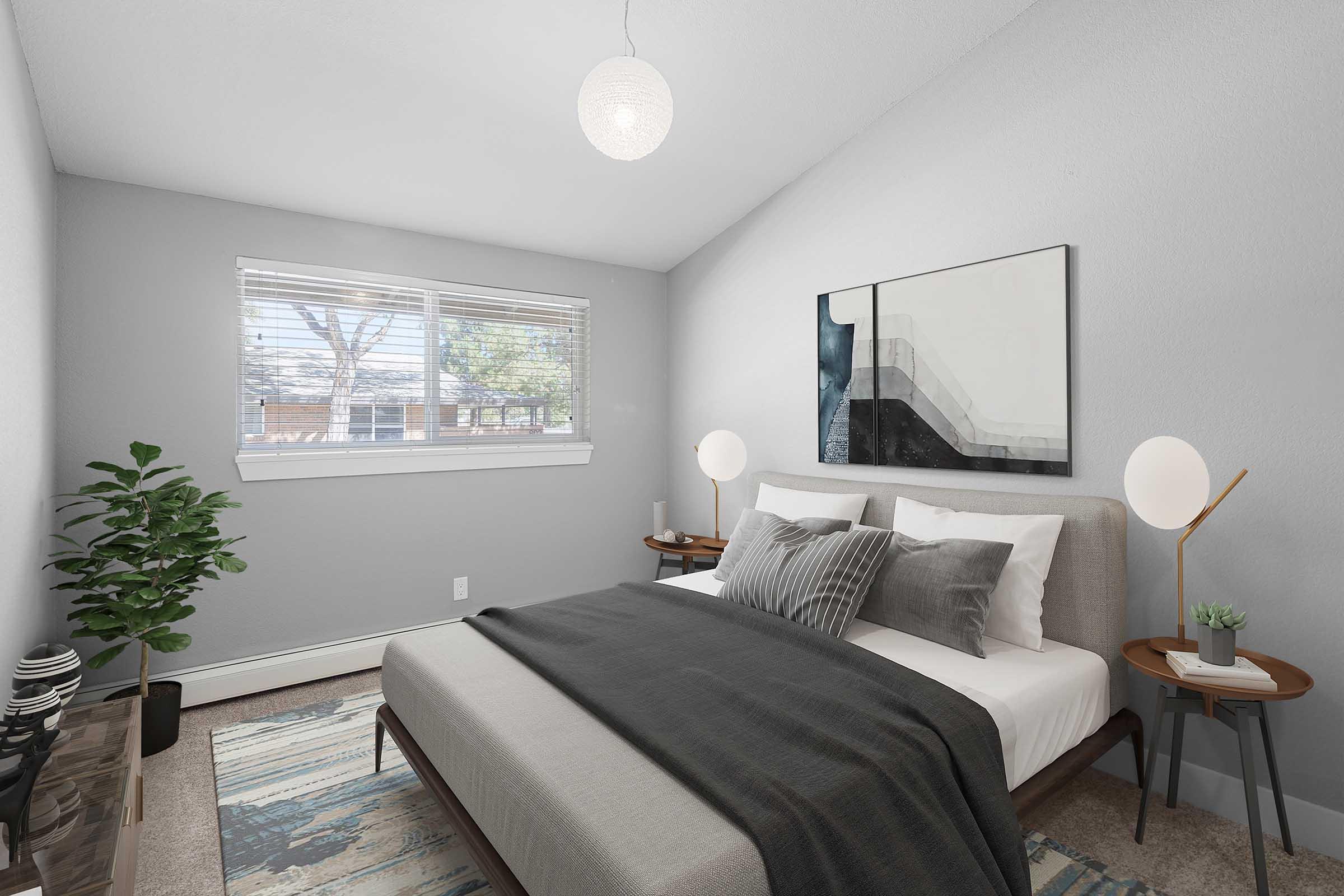 A modern bedroom featuring a neatly made bed with gray and white bedding, two decorative pillows, and a textured throw. There are nightstands on either side with stylish lamps. A large window allows natural light, and a potted plant adds a touch of greenery. Abstract wall art complements the serene atmosphere.