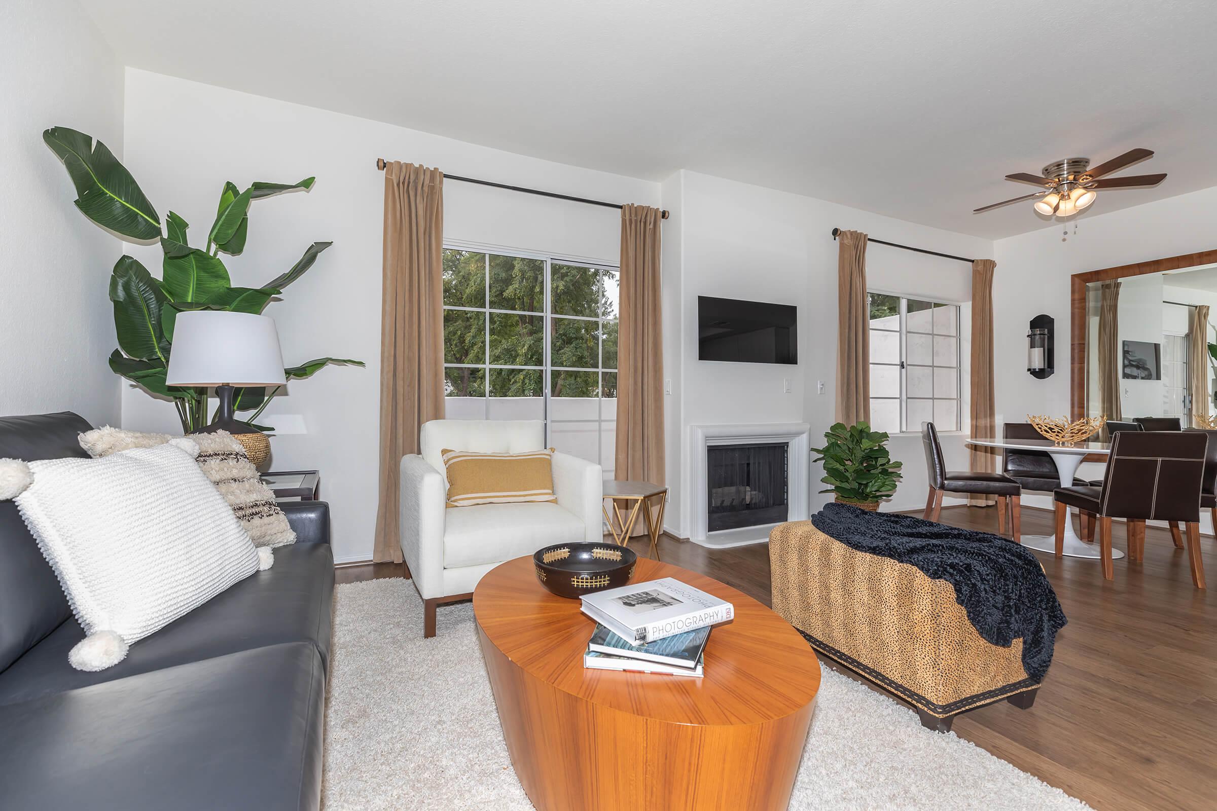 a living room filled with furniture and a large window