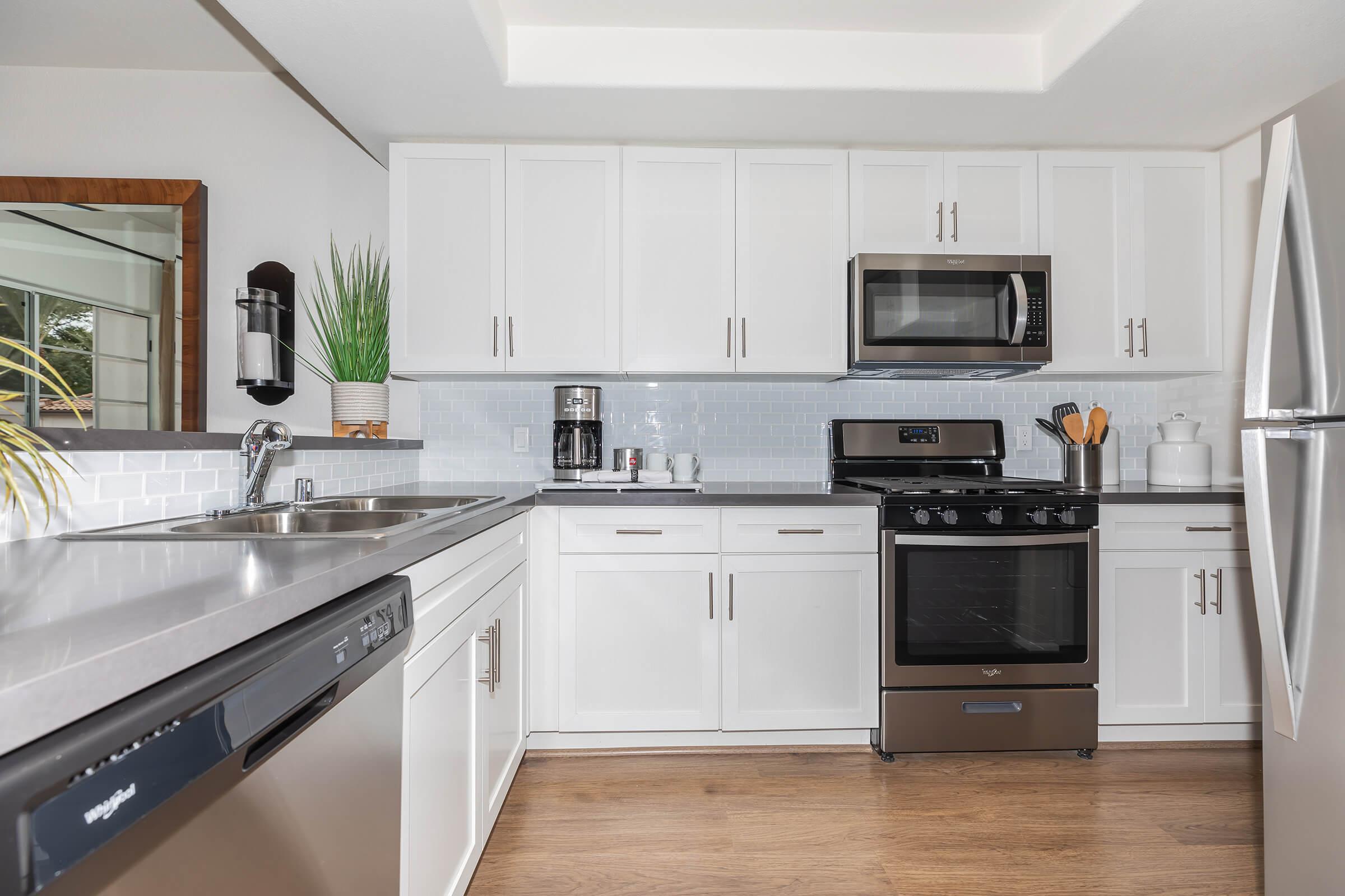 a stove top oven sitting inside of a kitchen