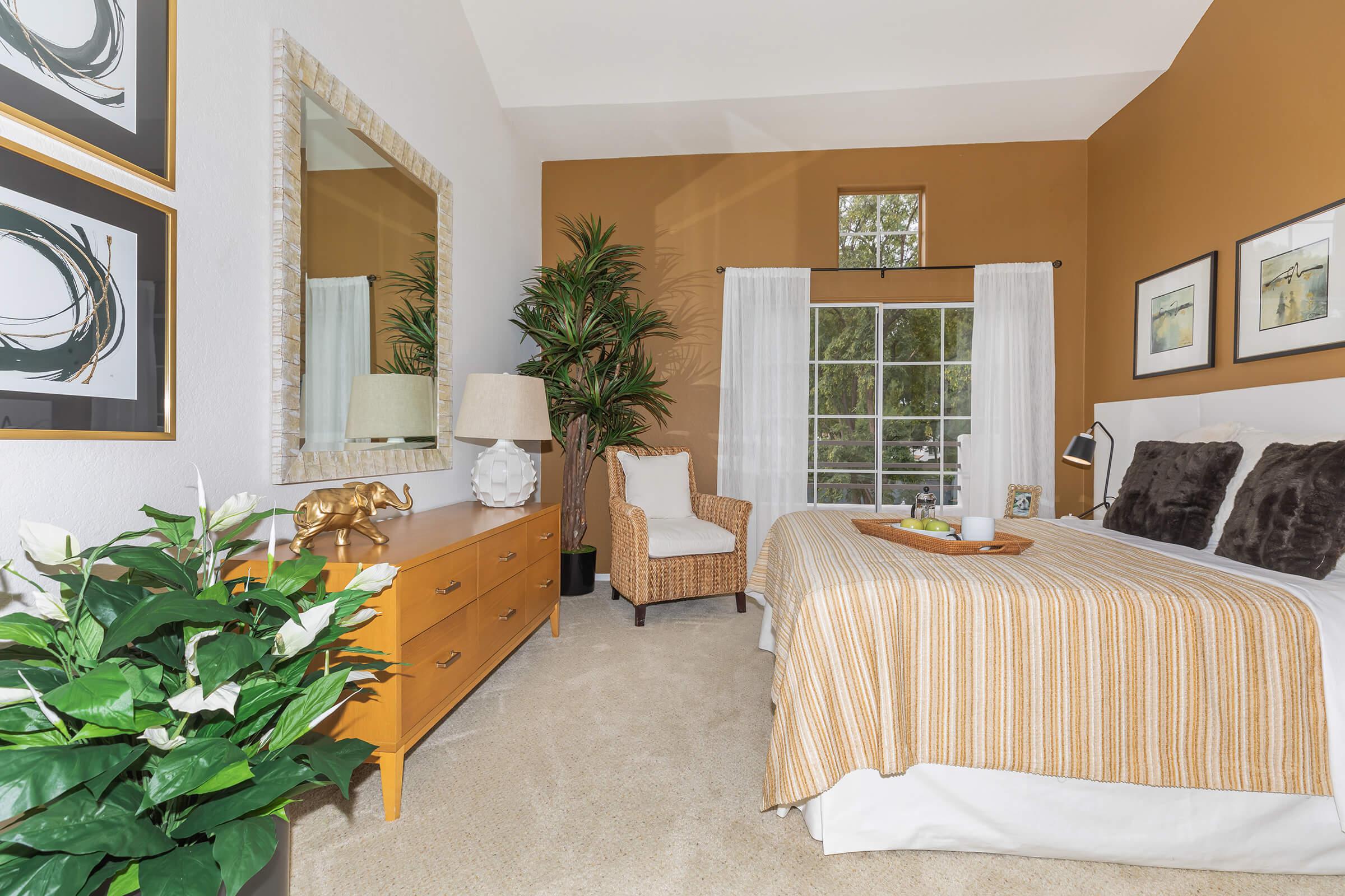 a living room filled with furniture and a bed