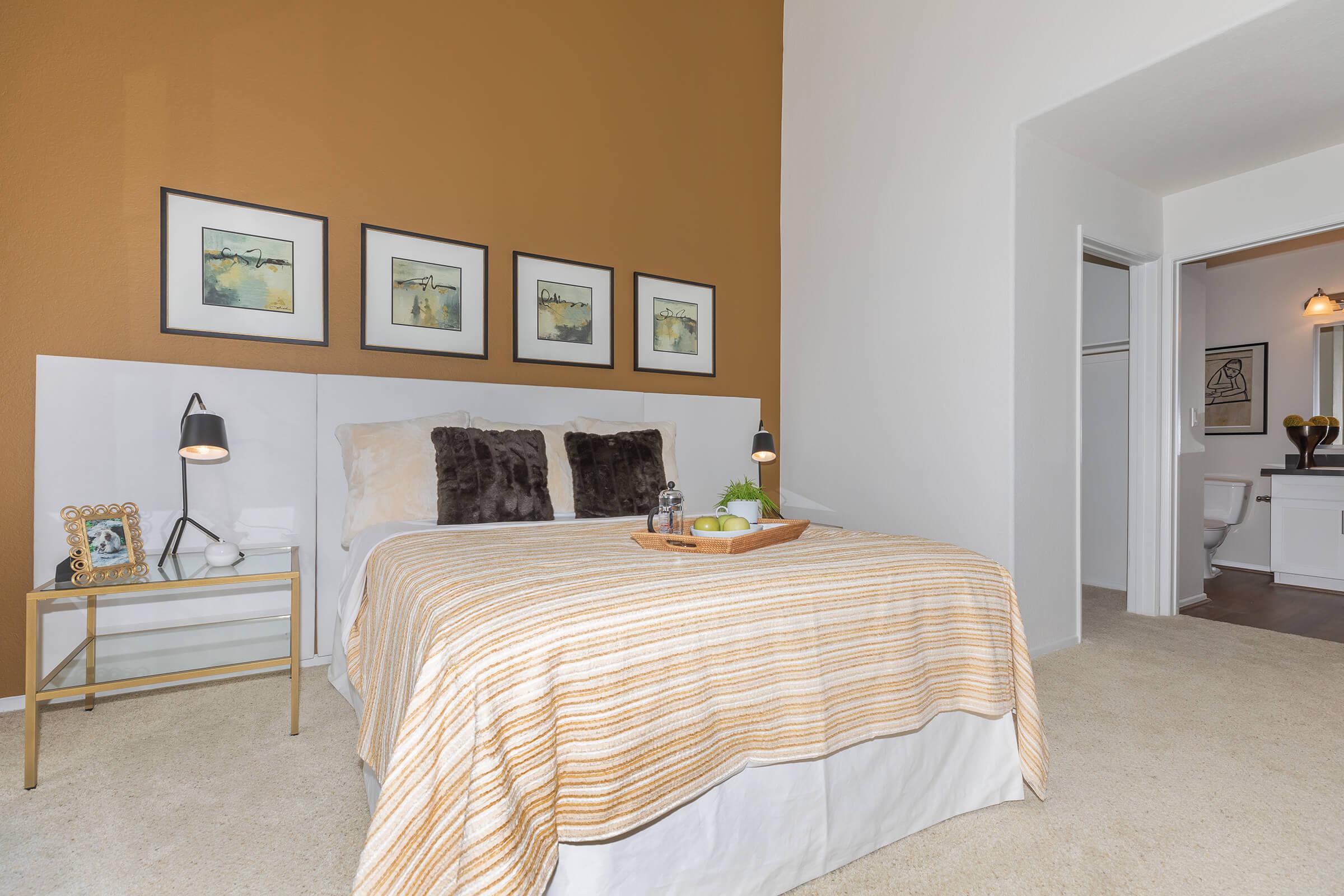 a bedroom with a bed and desk in a room