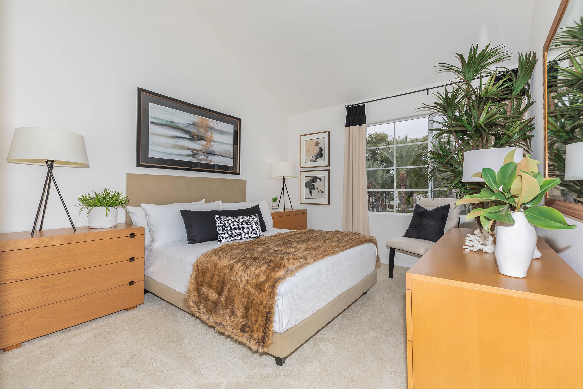 a bedroom with a bed and desk in a room