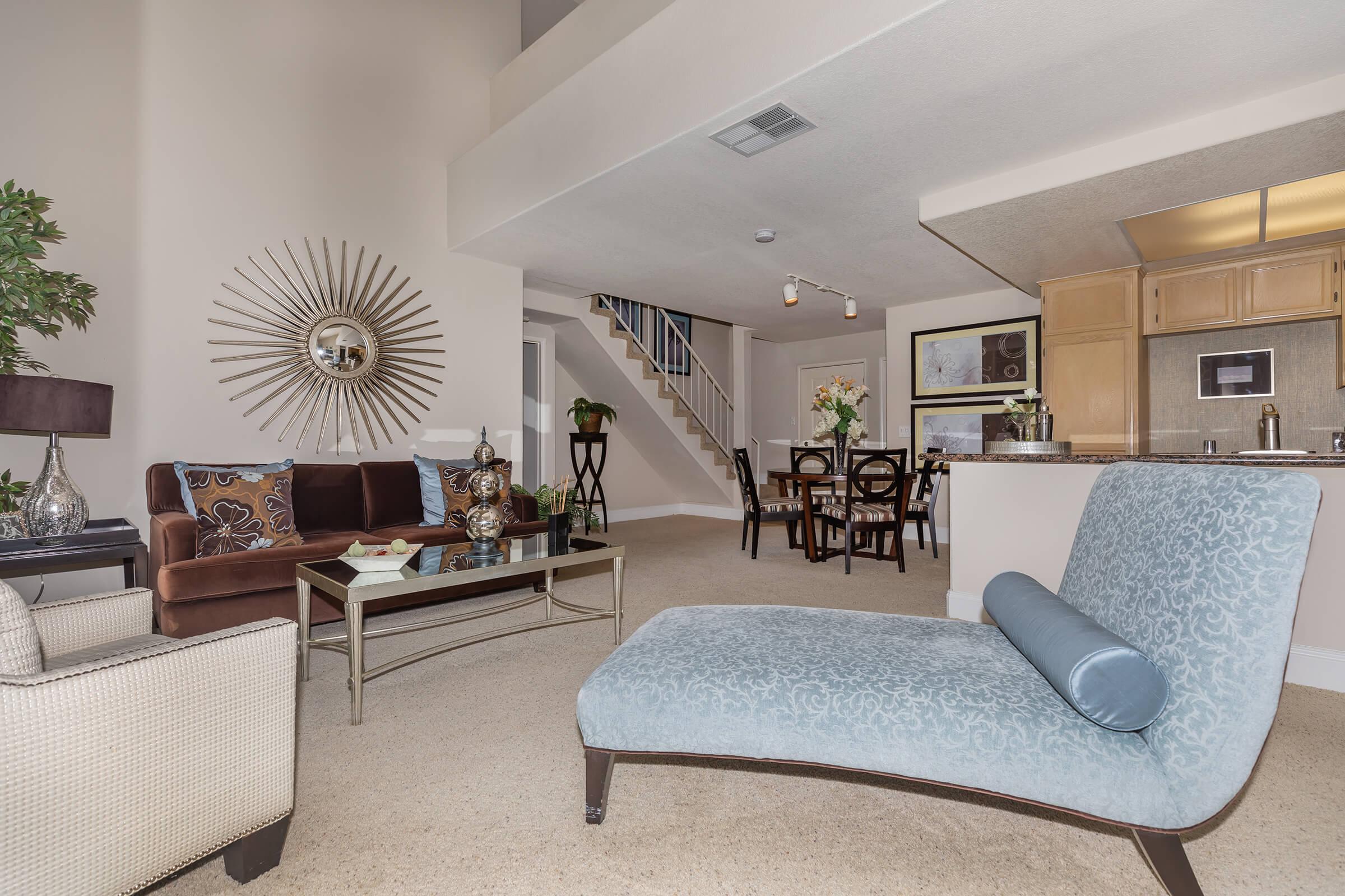 a living room filled with furniture and a large window