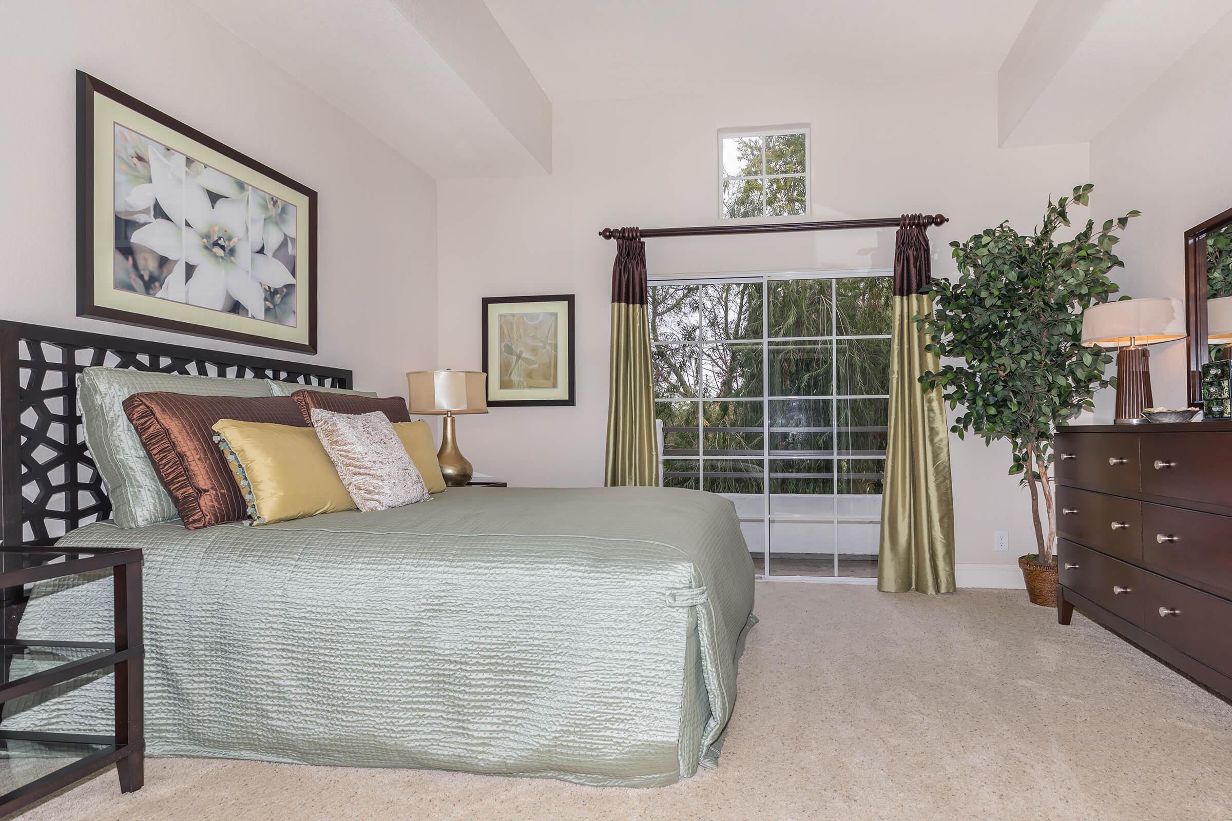 a bedroom with a bed and a chair in a room