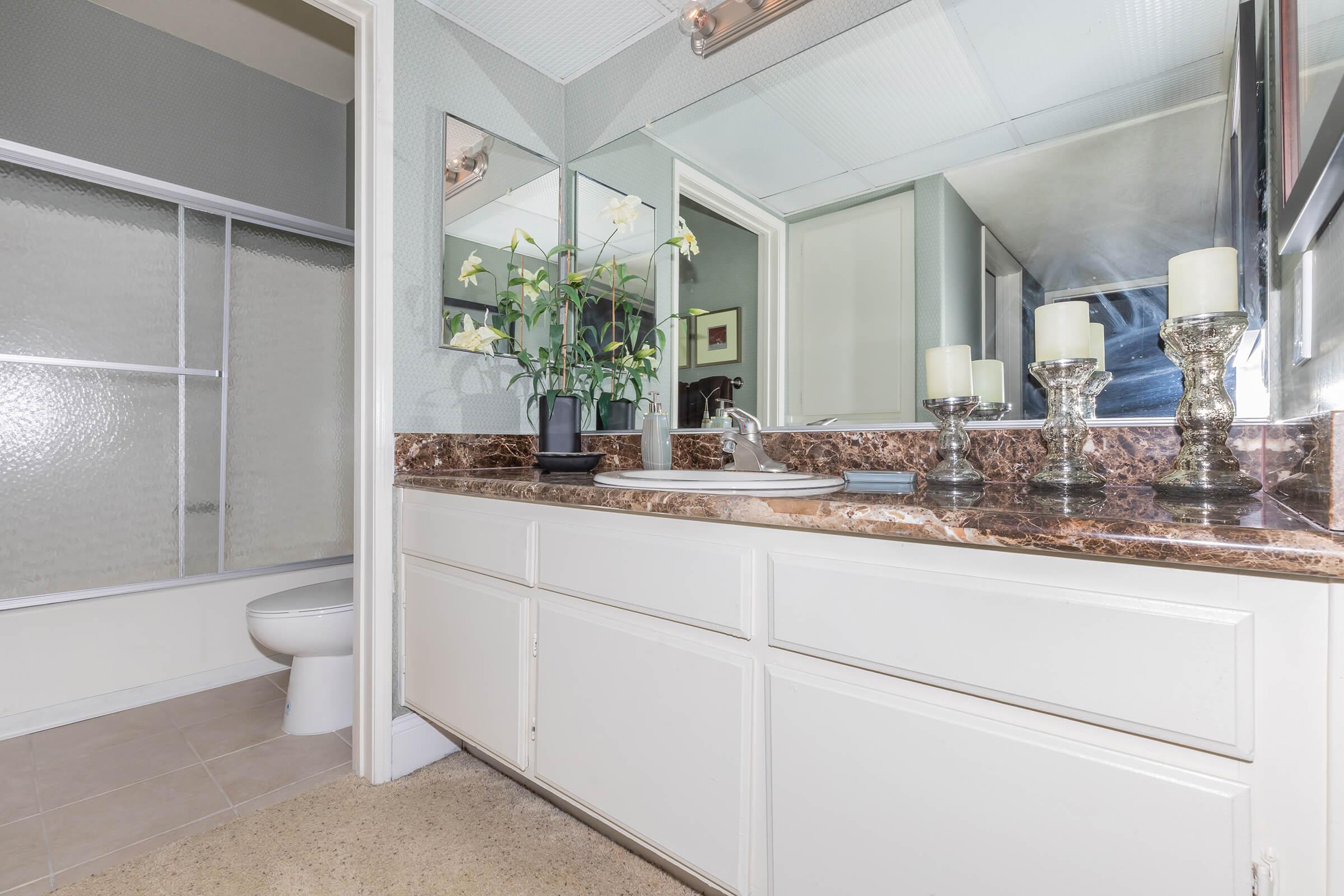 a kitchen with a sink and a mirror