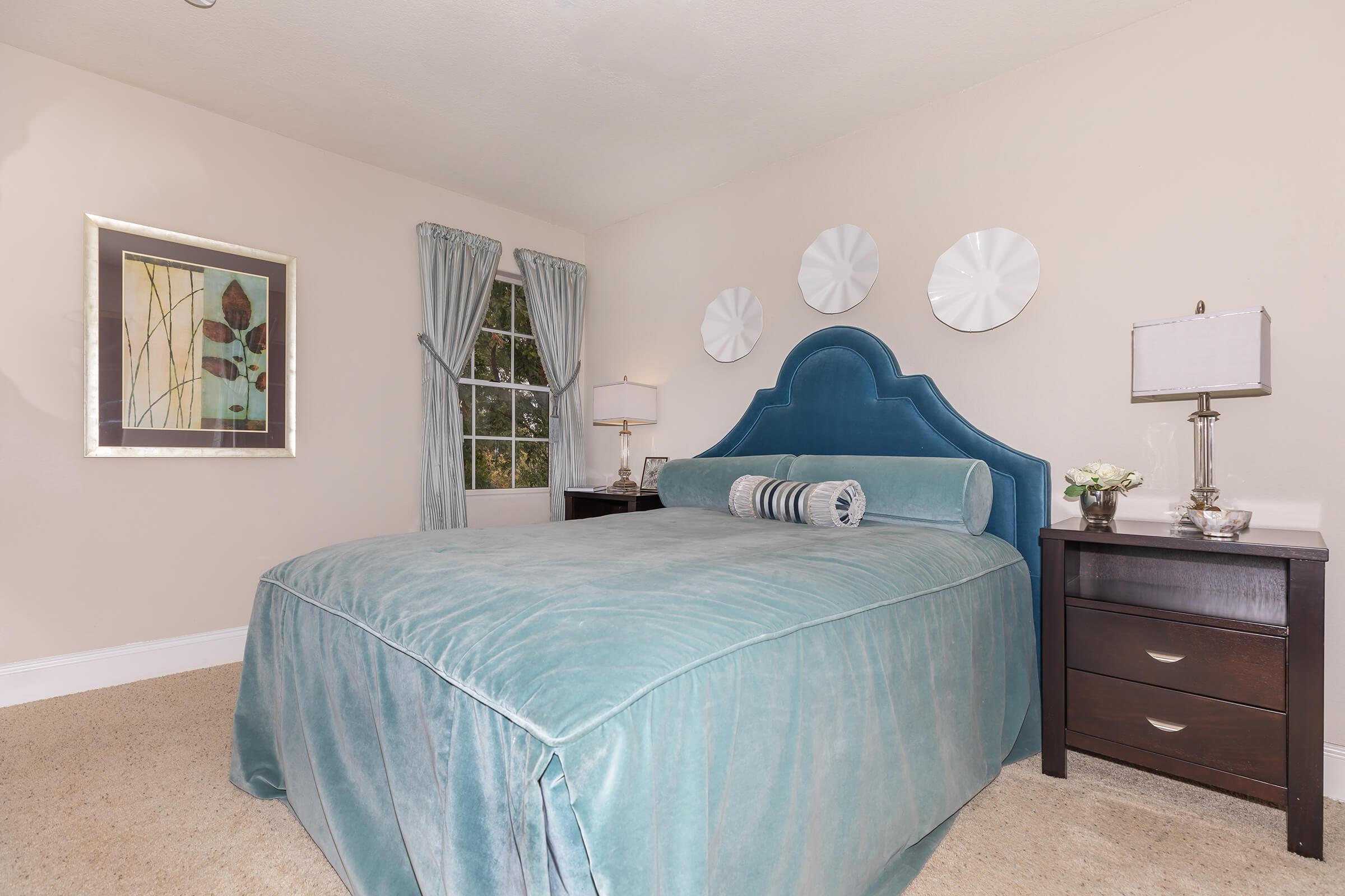 a bedroom with a bed in a room