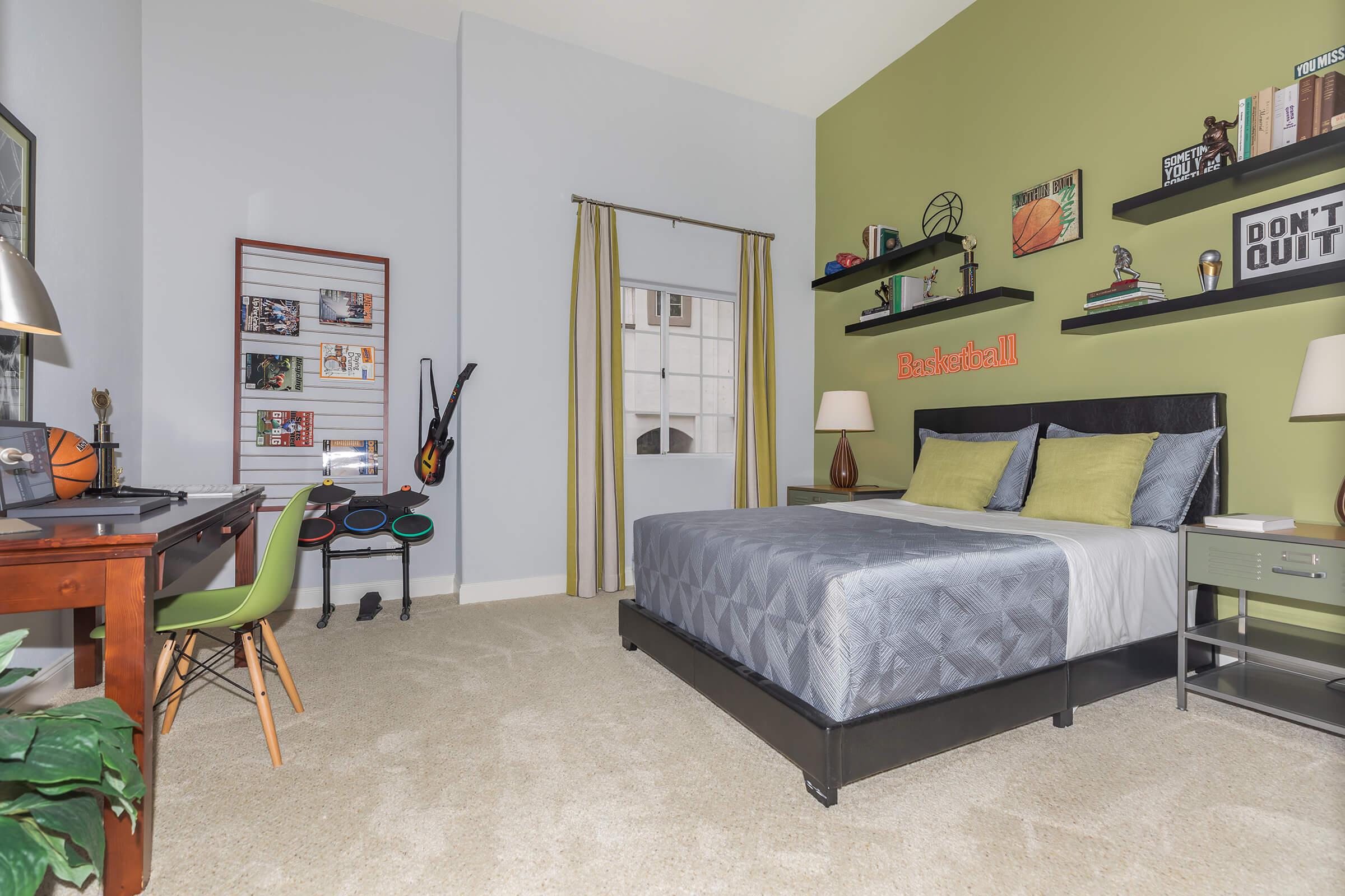 a bedroom with a bed and desk in a room