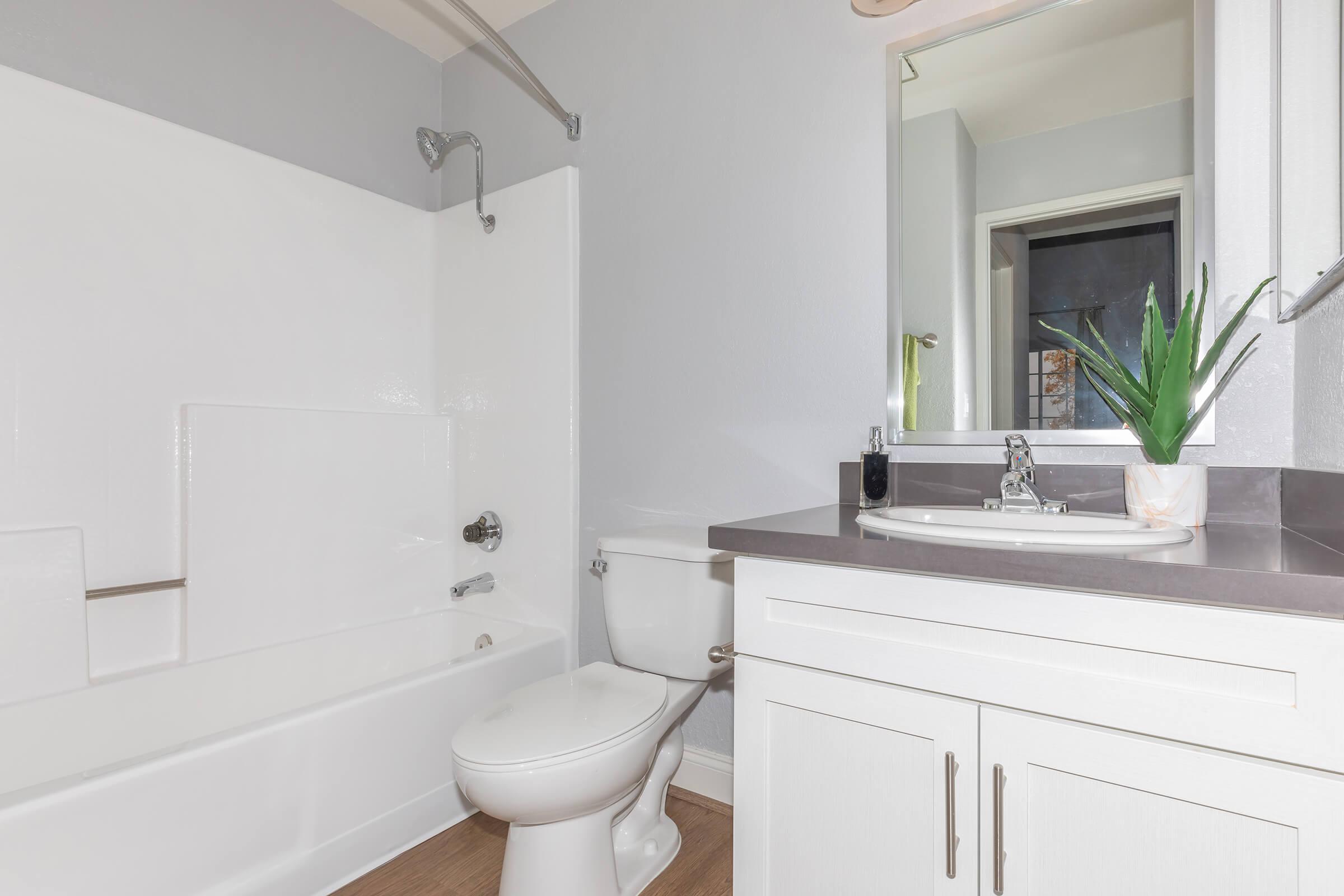 a white sink sitting under a window