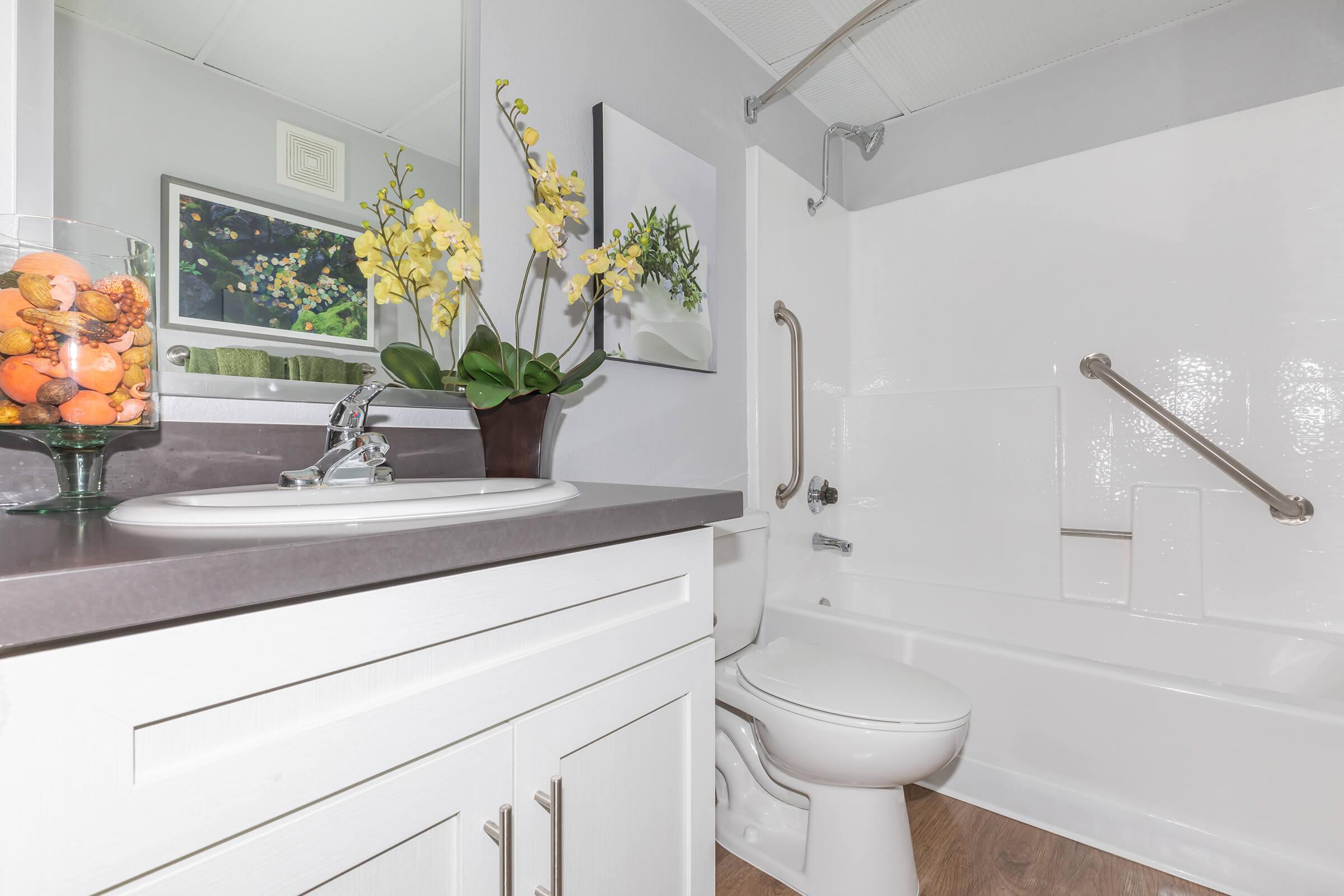 a white sink sitting under a window