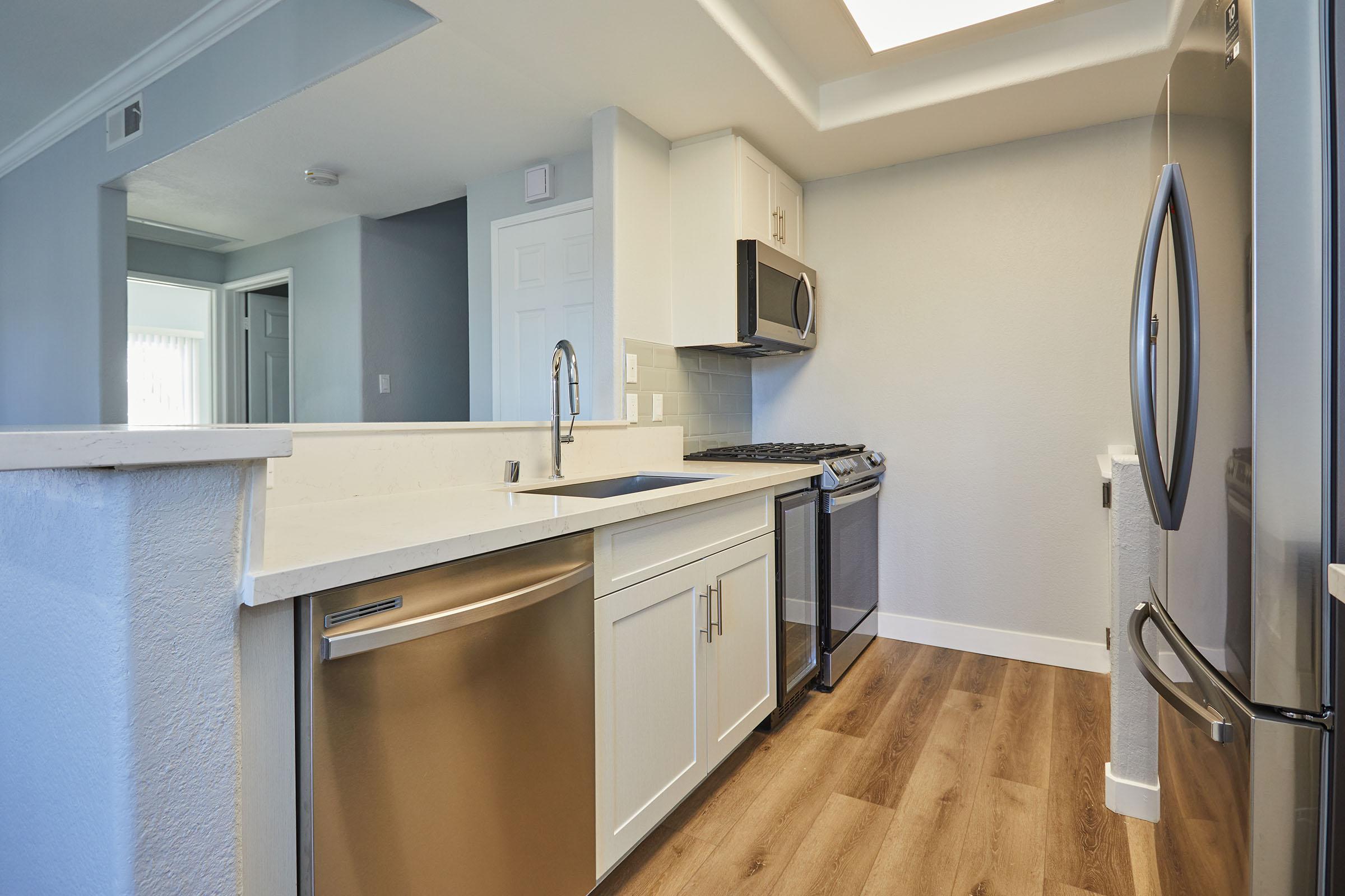 a kitchen with a sink and a refrigerator