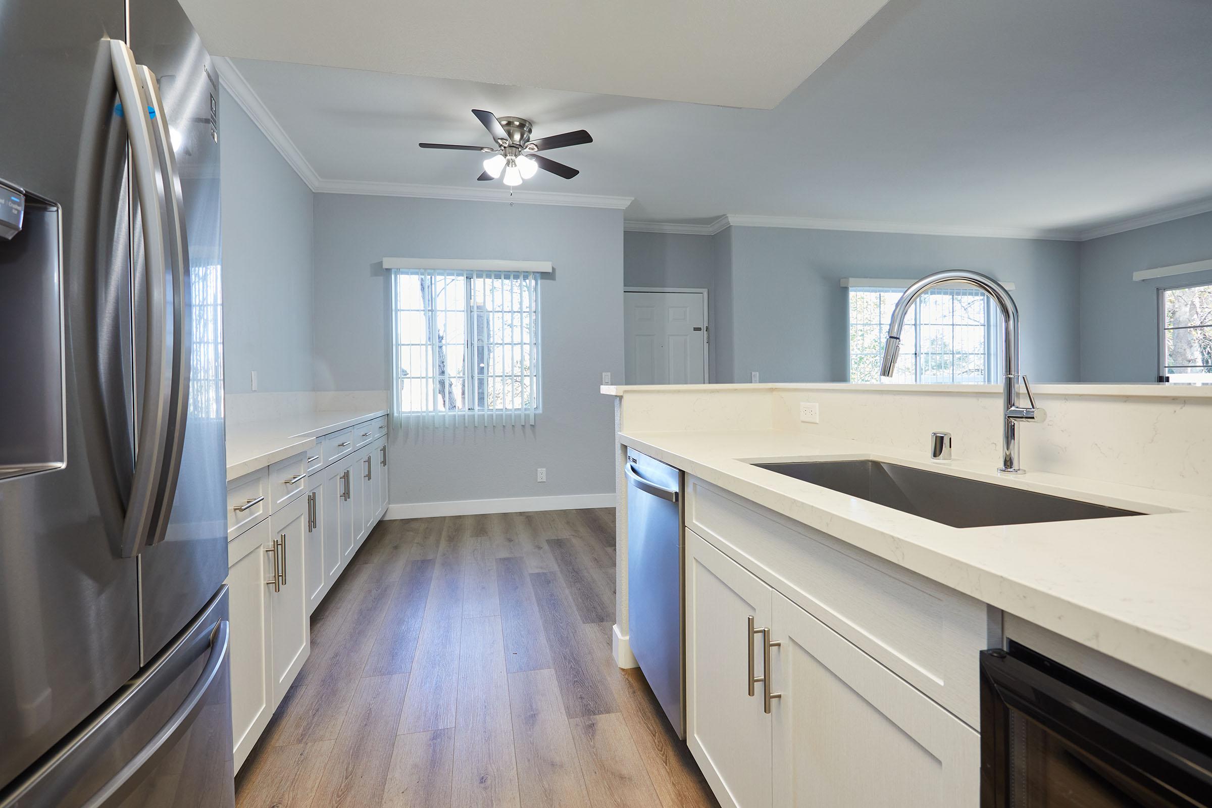 a kitchen with a stove sink and refrigerator