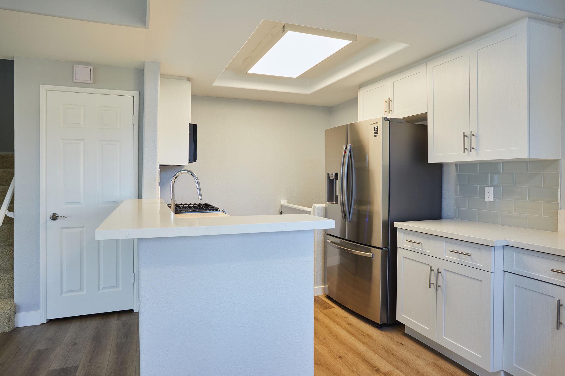 a kitchen with a stove and a refrigerator