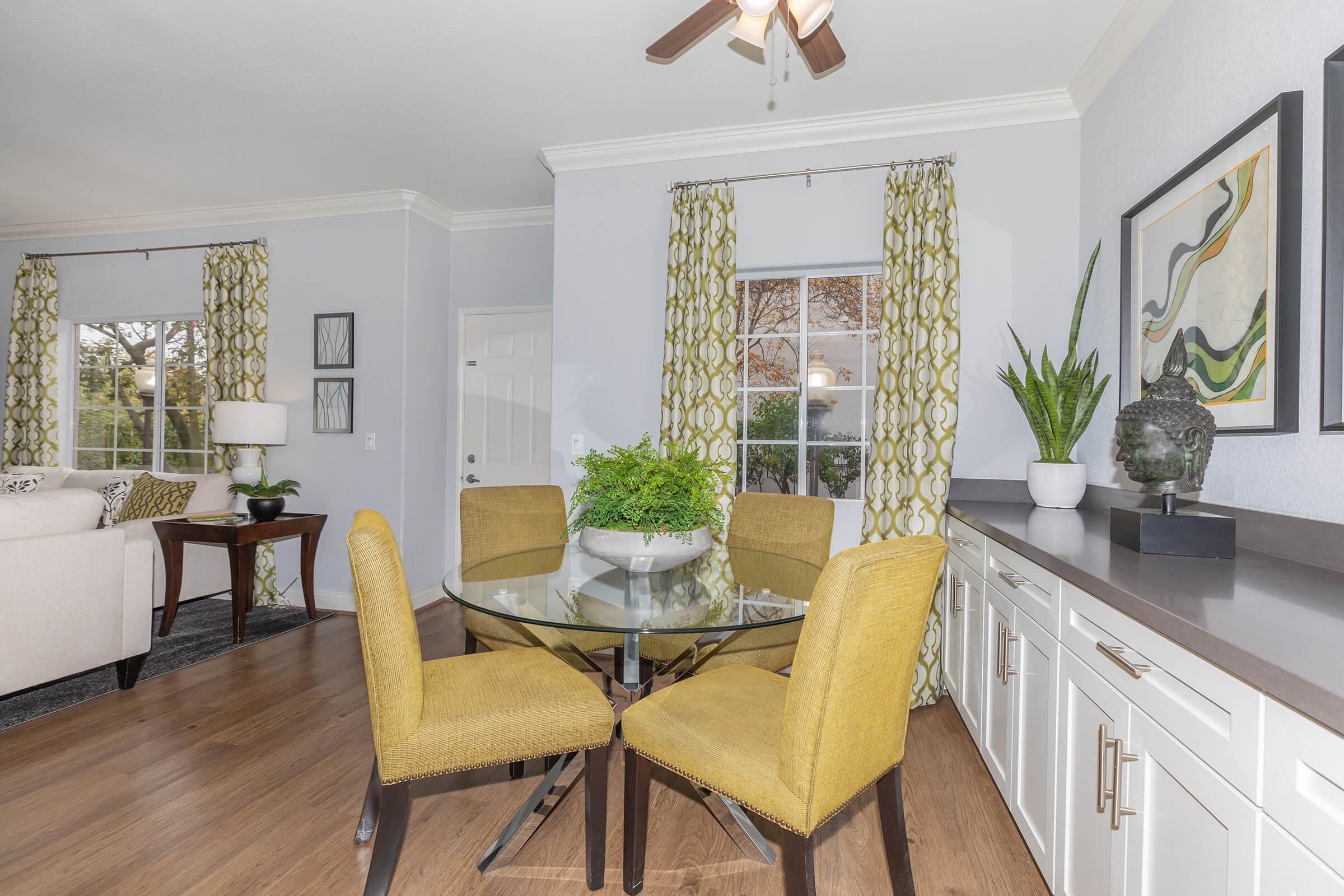 a living room filled with furniture and a mirror