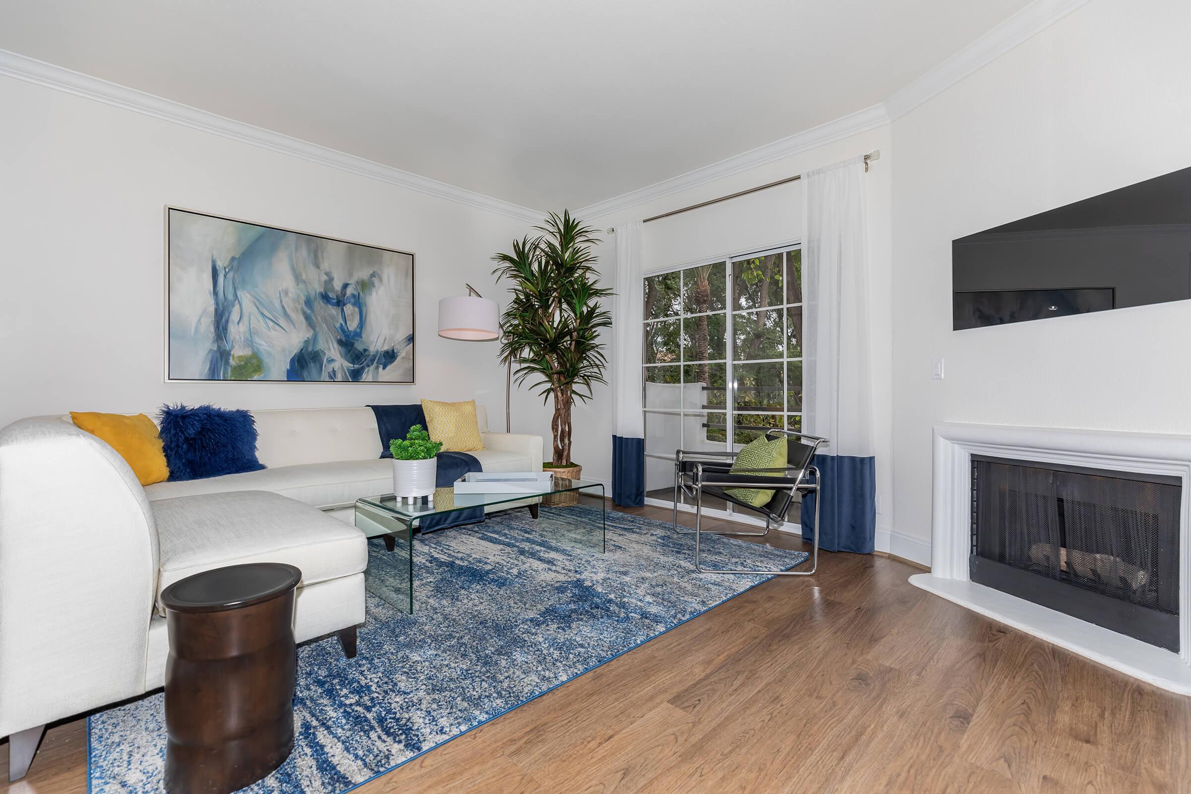 a living room filled with furniture and a fireplace