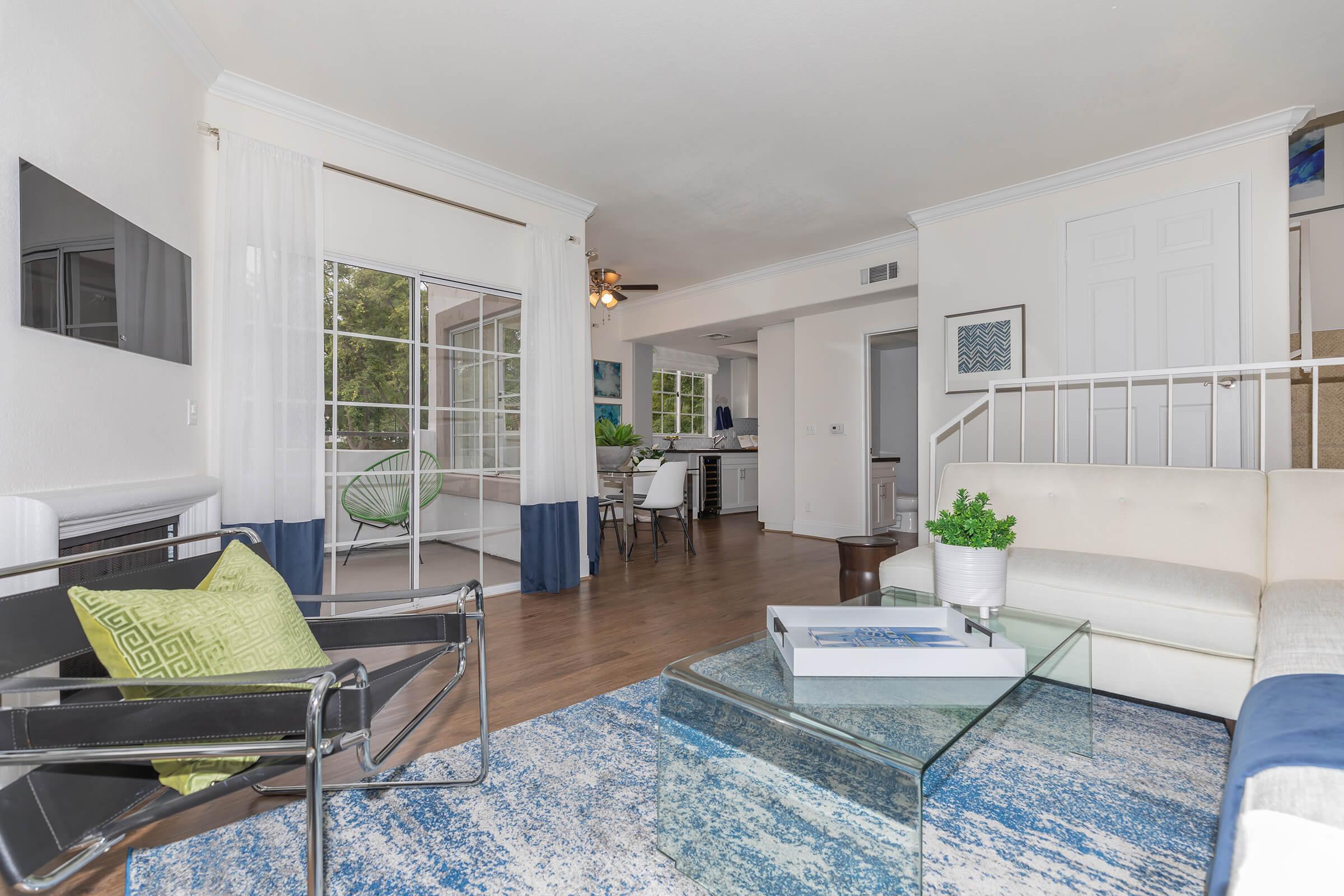 a living room filled with furniture and a large window