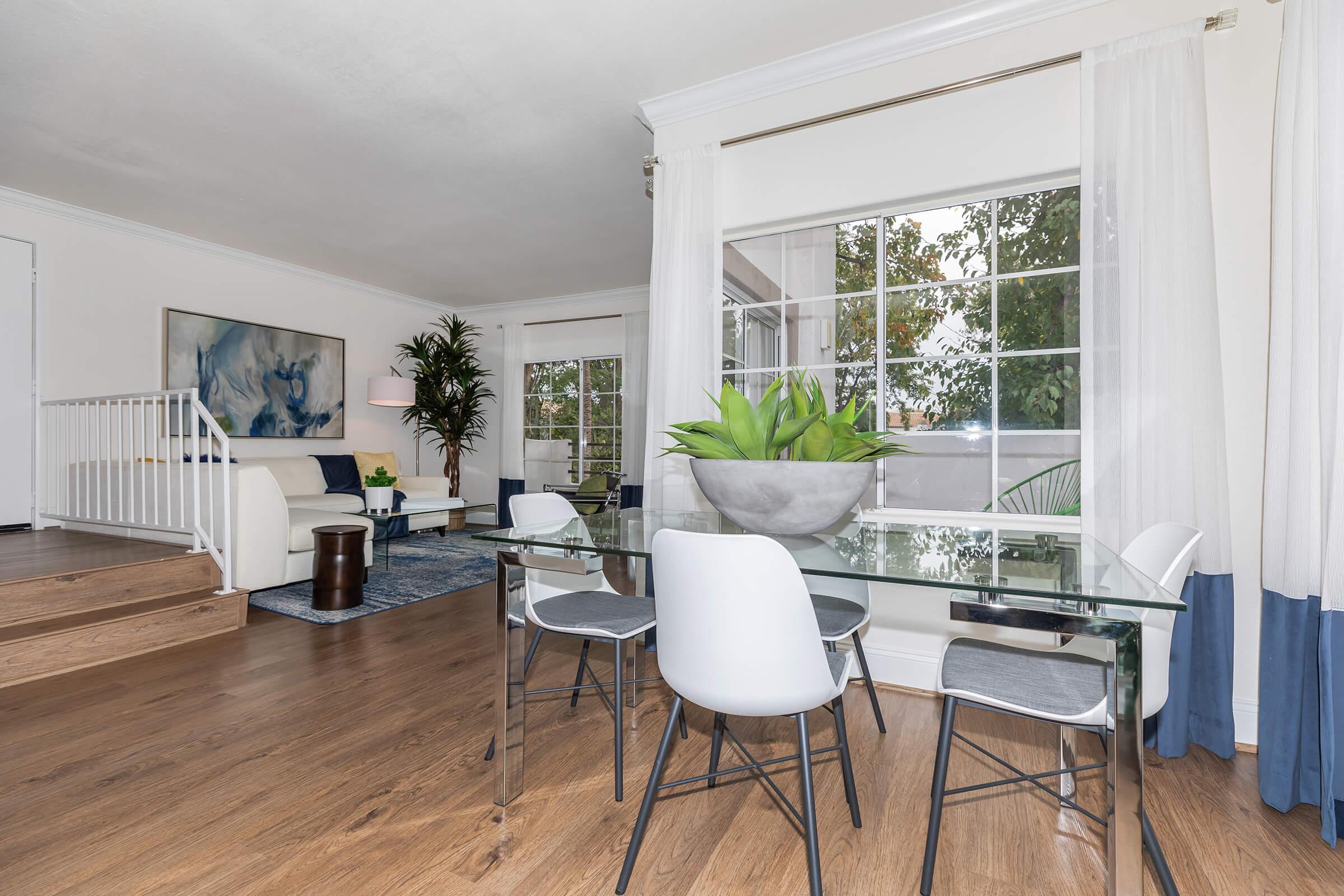 a living room filled with furniture and a large window