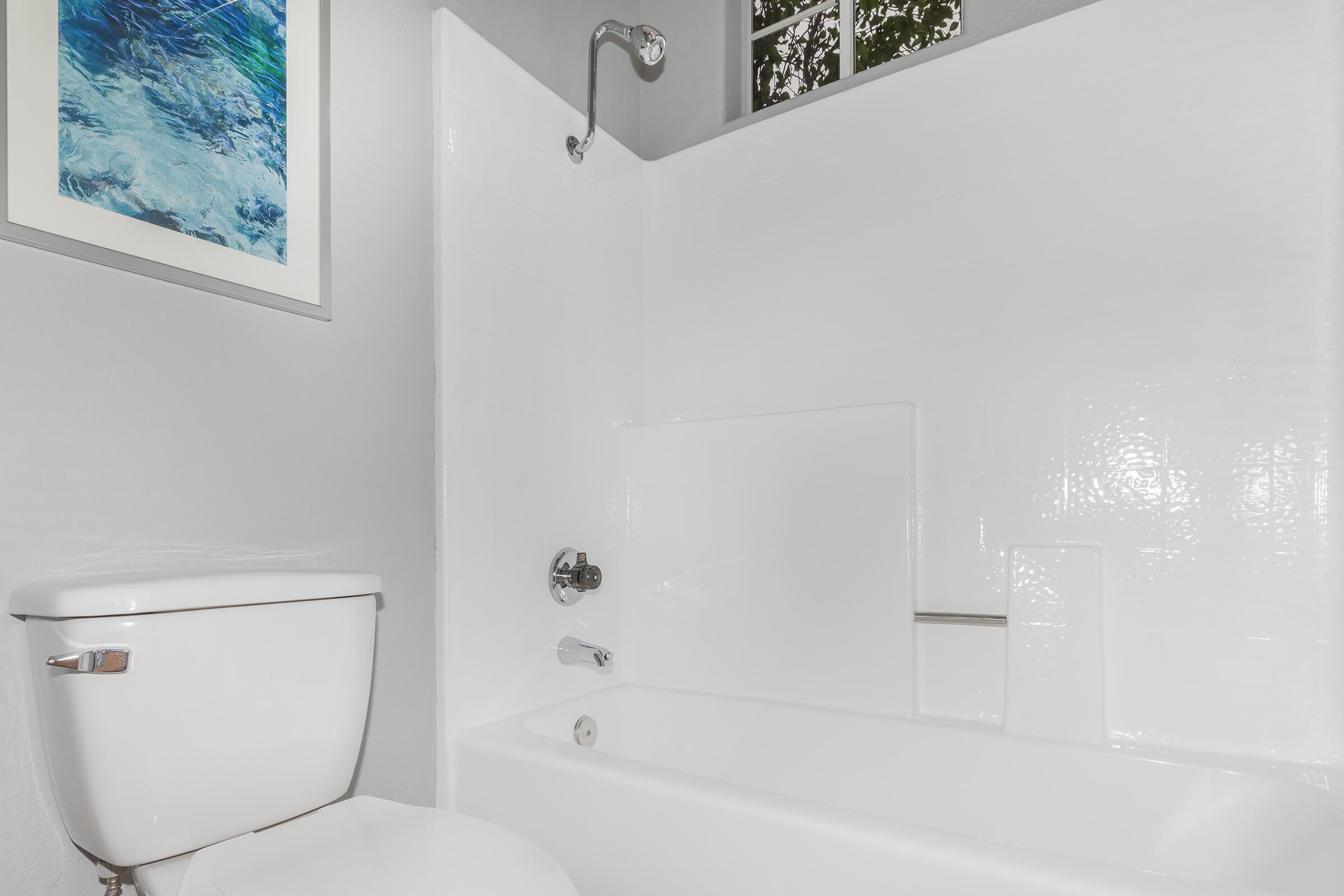 a white tub sitting next to a shower