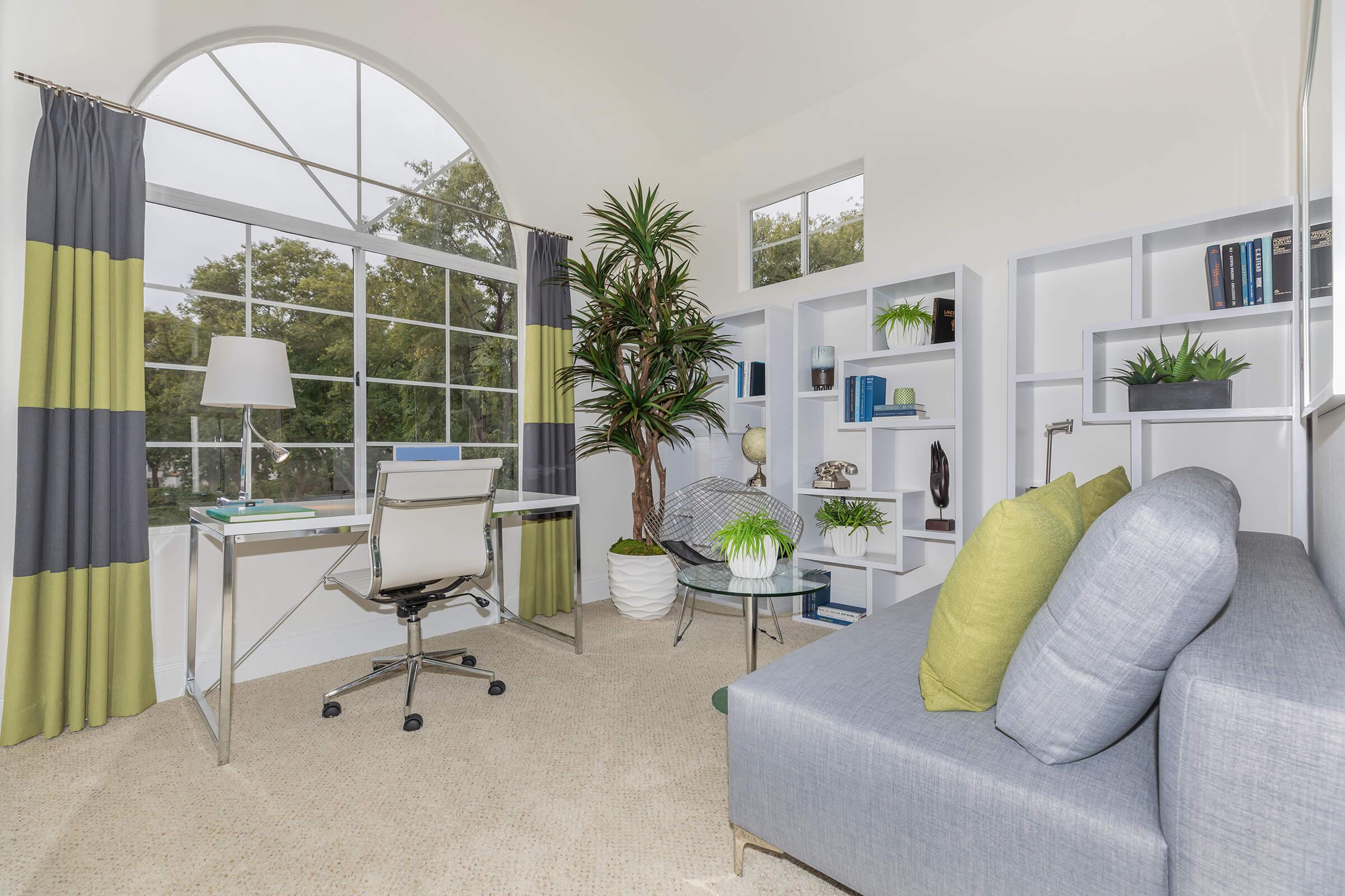 a living room filled with furniture and a large window