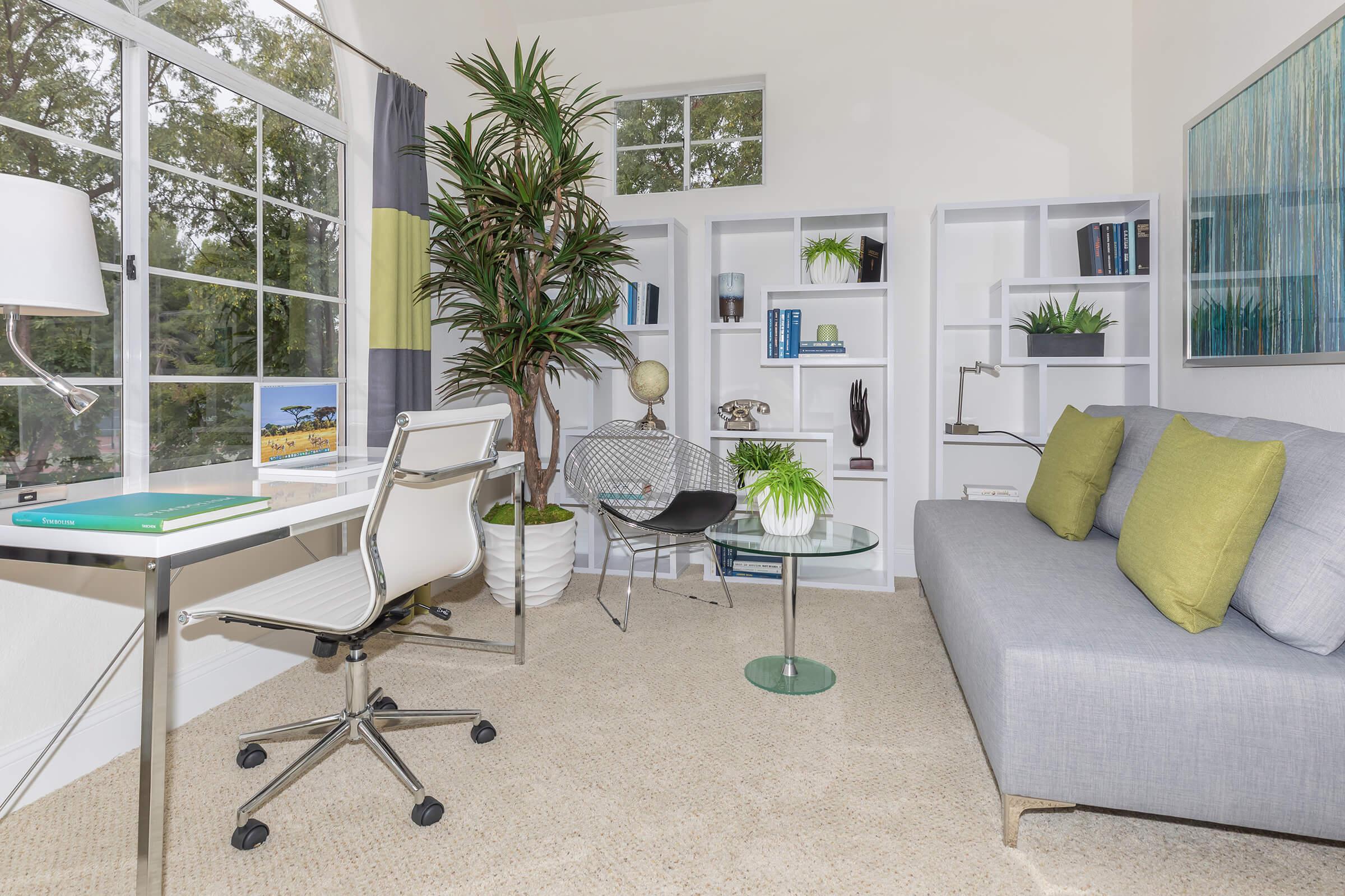 a living room filled with furniture and a large window