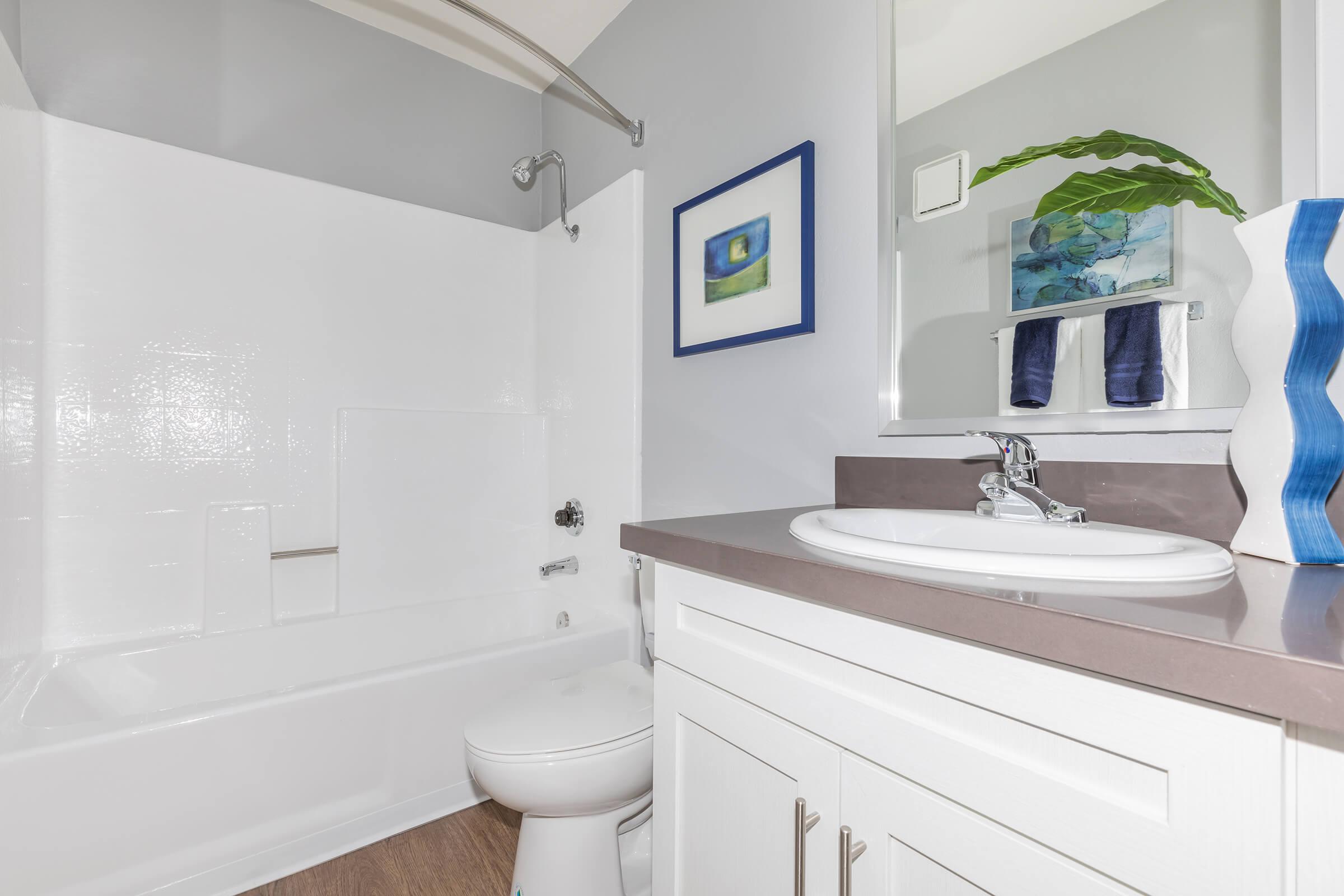 a white tub sitting next to a sink