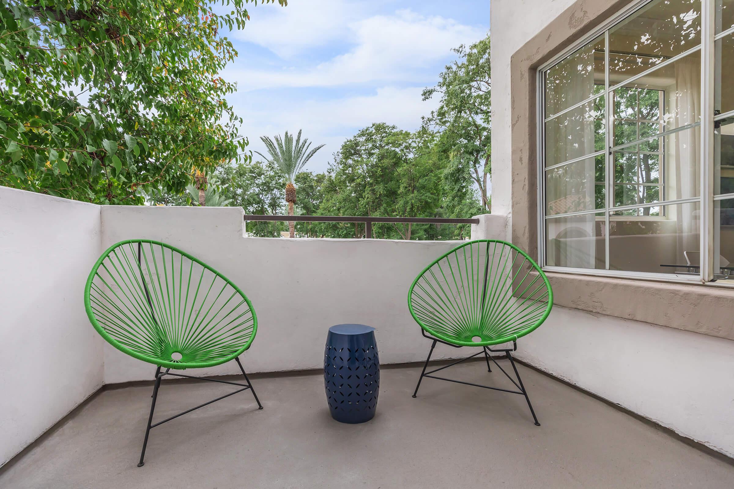 a green chair in front of a building