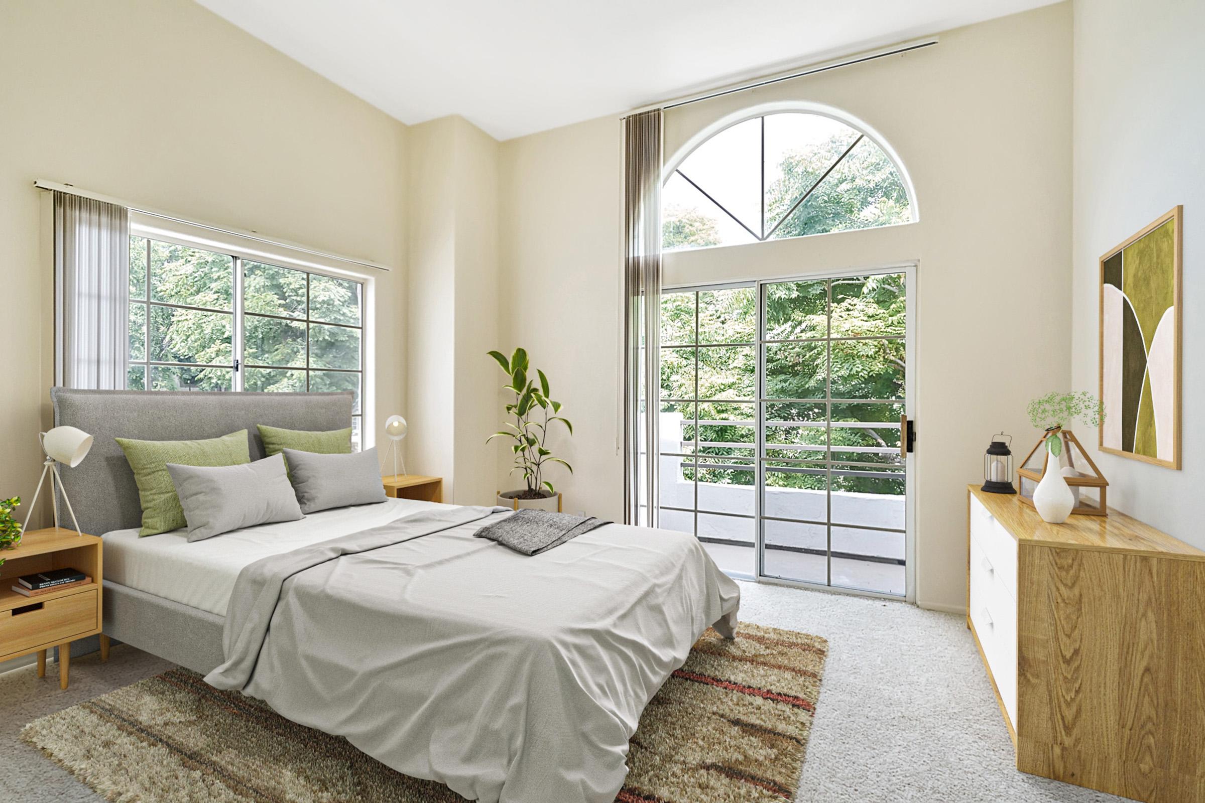 a bedroom with a bed and a large window