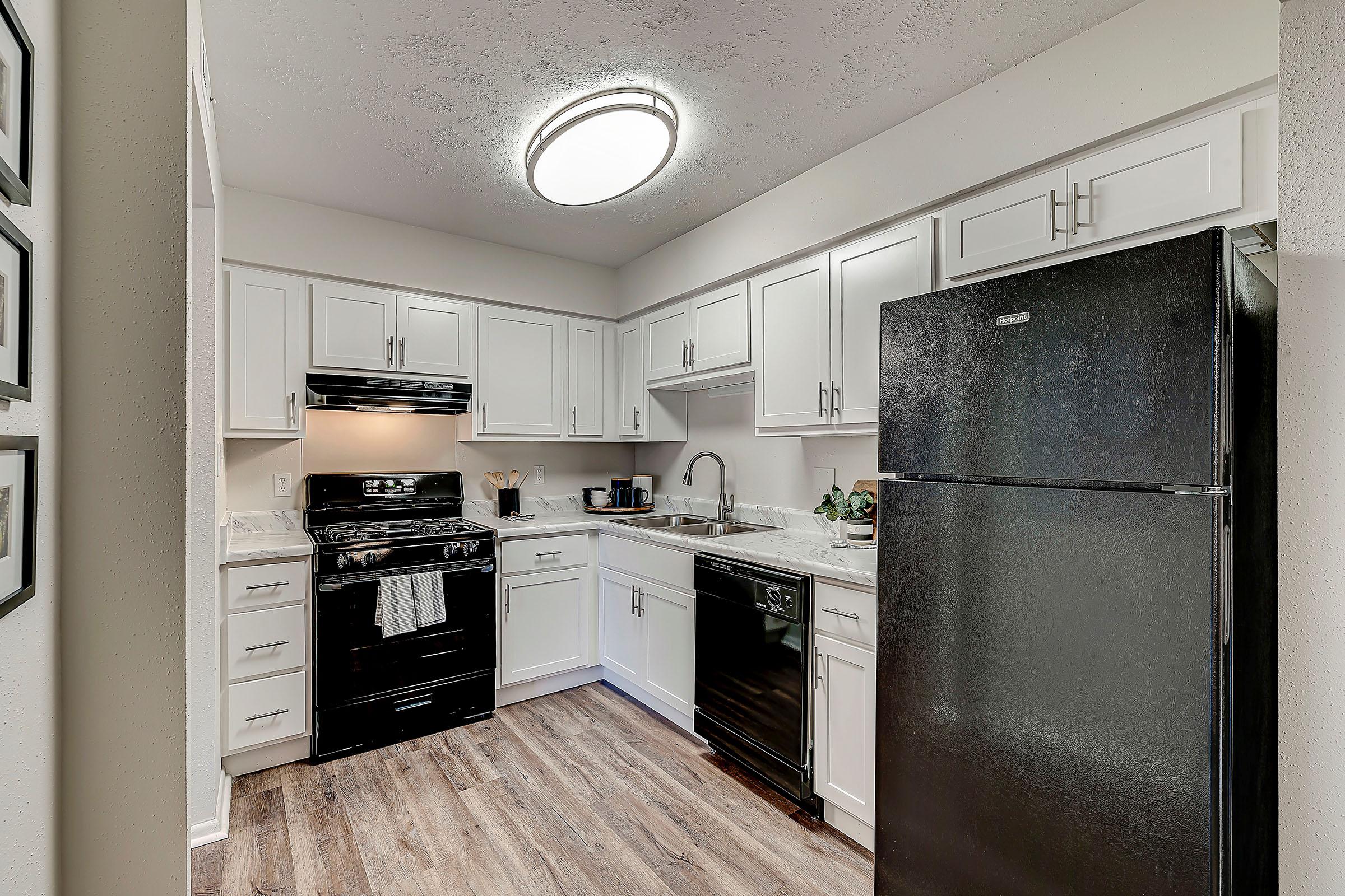 a kitchen with a sink and a refrigerator