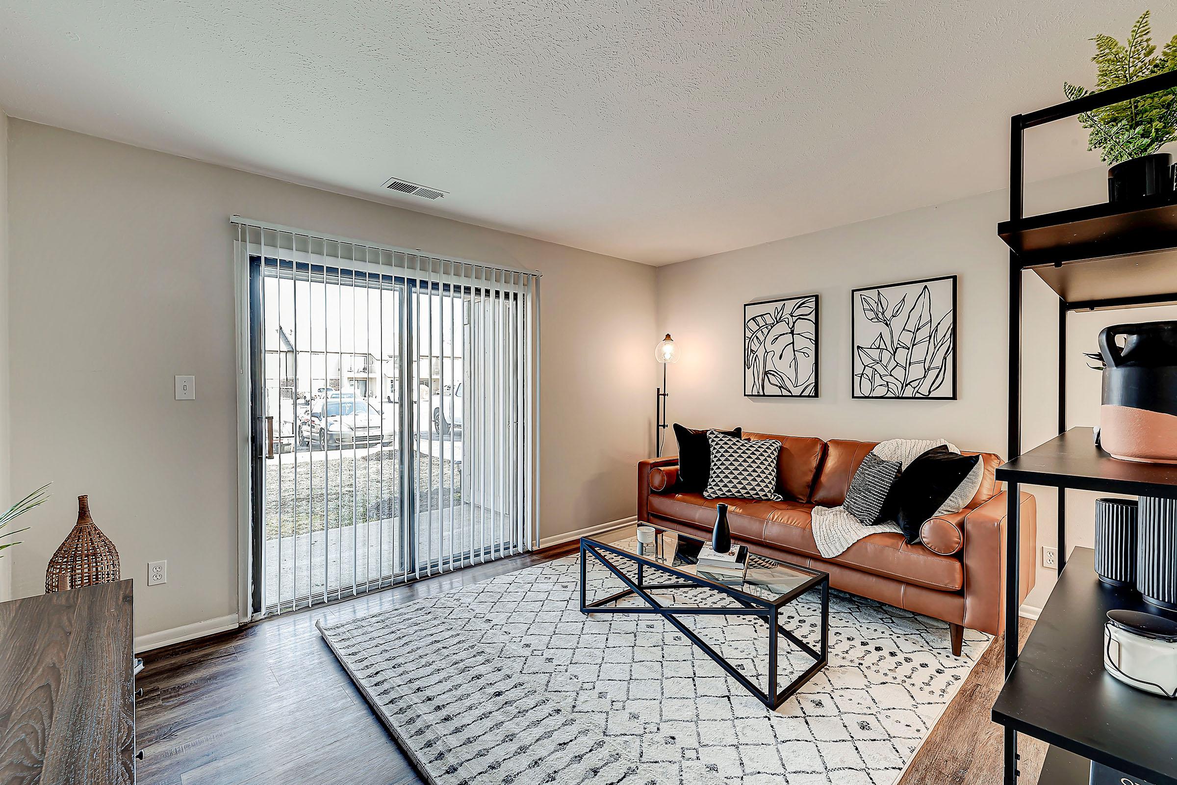 a bedroom with a bed and a chair in a room