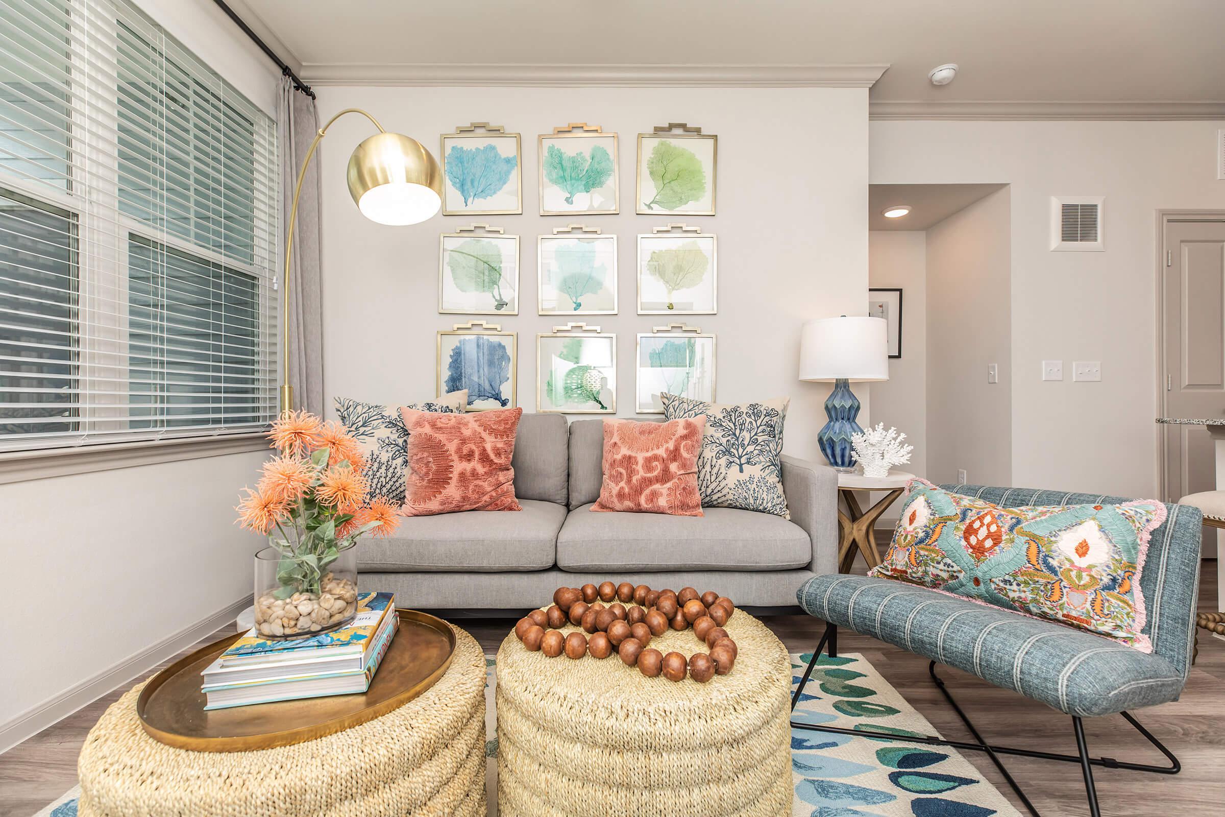 a living room filled with furniture and a large window