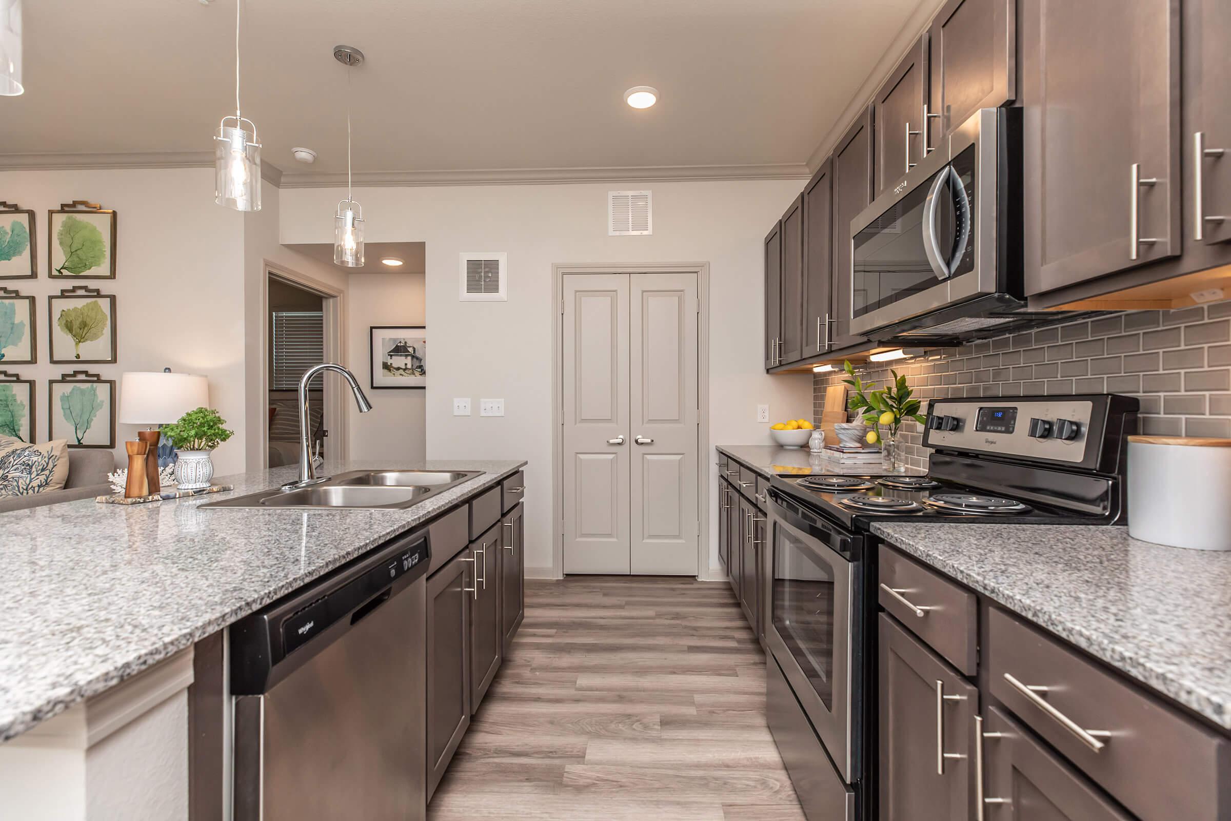 a modern kitchen with stainless steel appliances and wooden cabinets