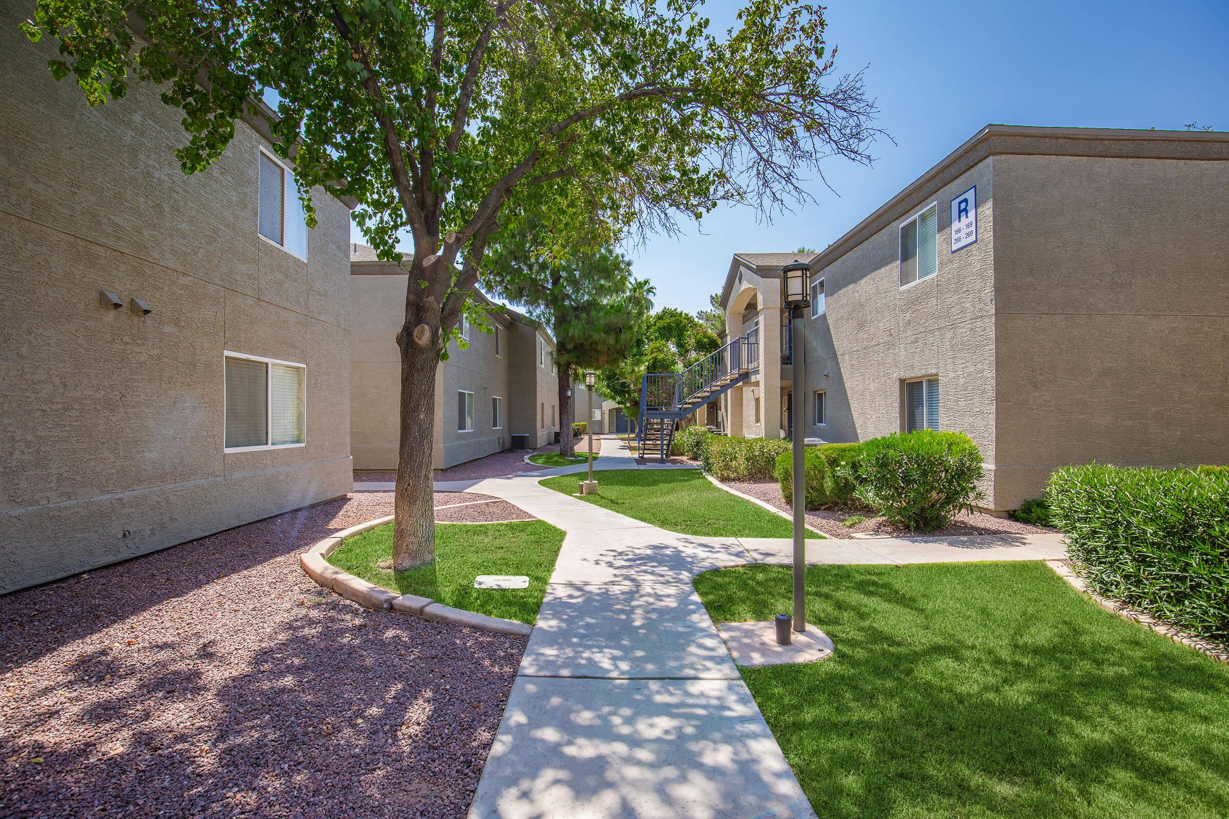 a stone path in front of a brick building