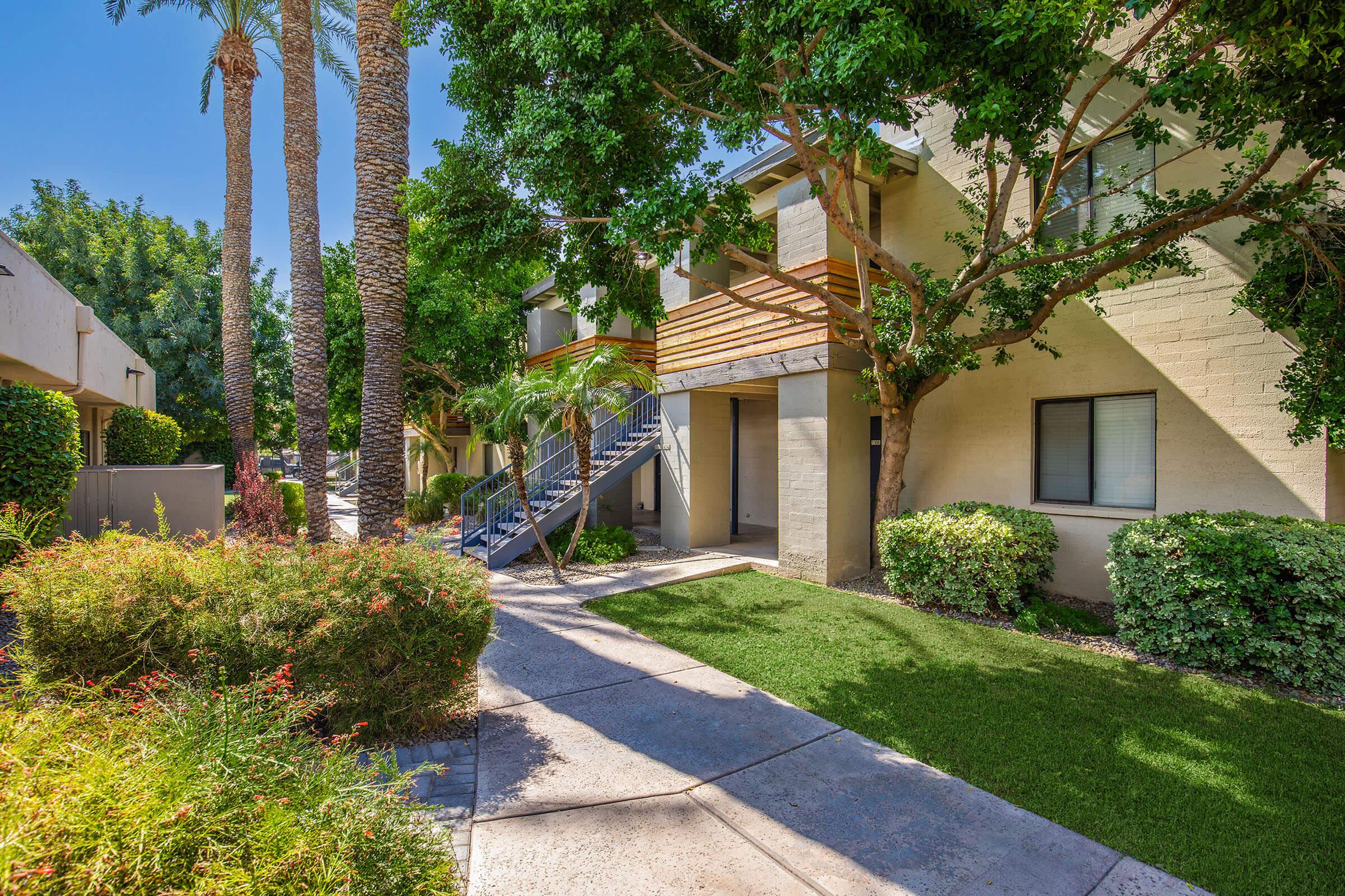 a house with bushes in front of a building