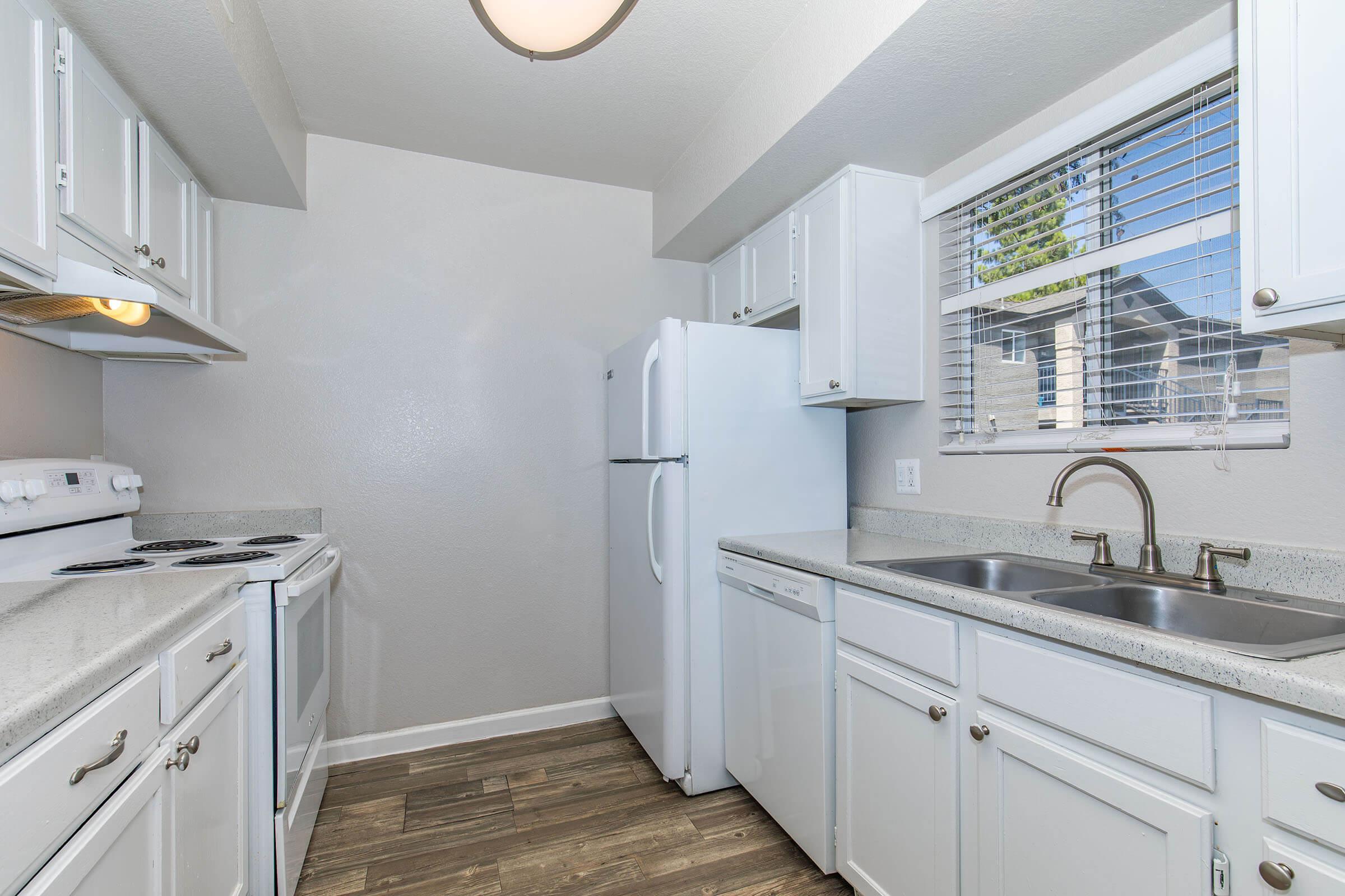 a kitchen with a sink and a refrigerator