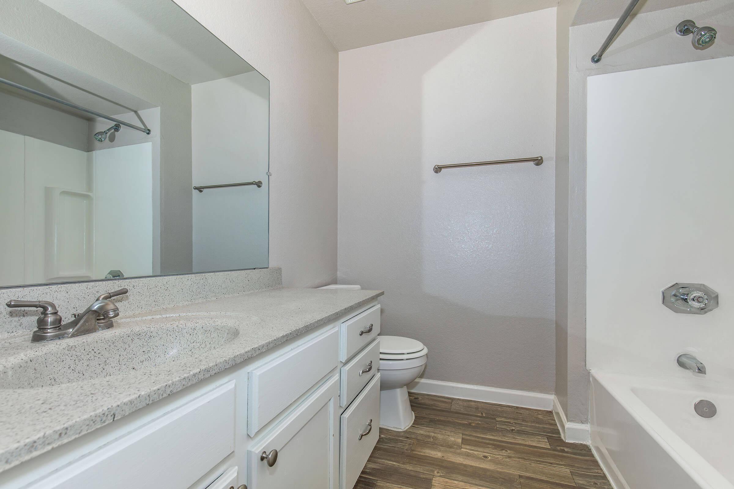 a kitchen with a sink and a mirror