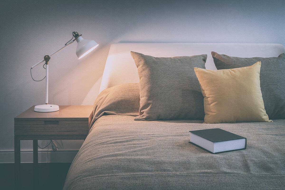 a lamp that is sitting on a bed