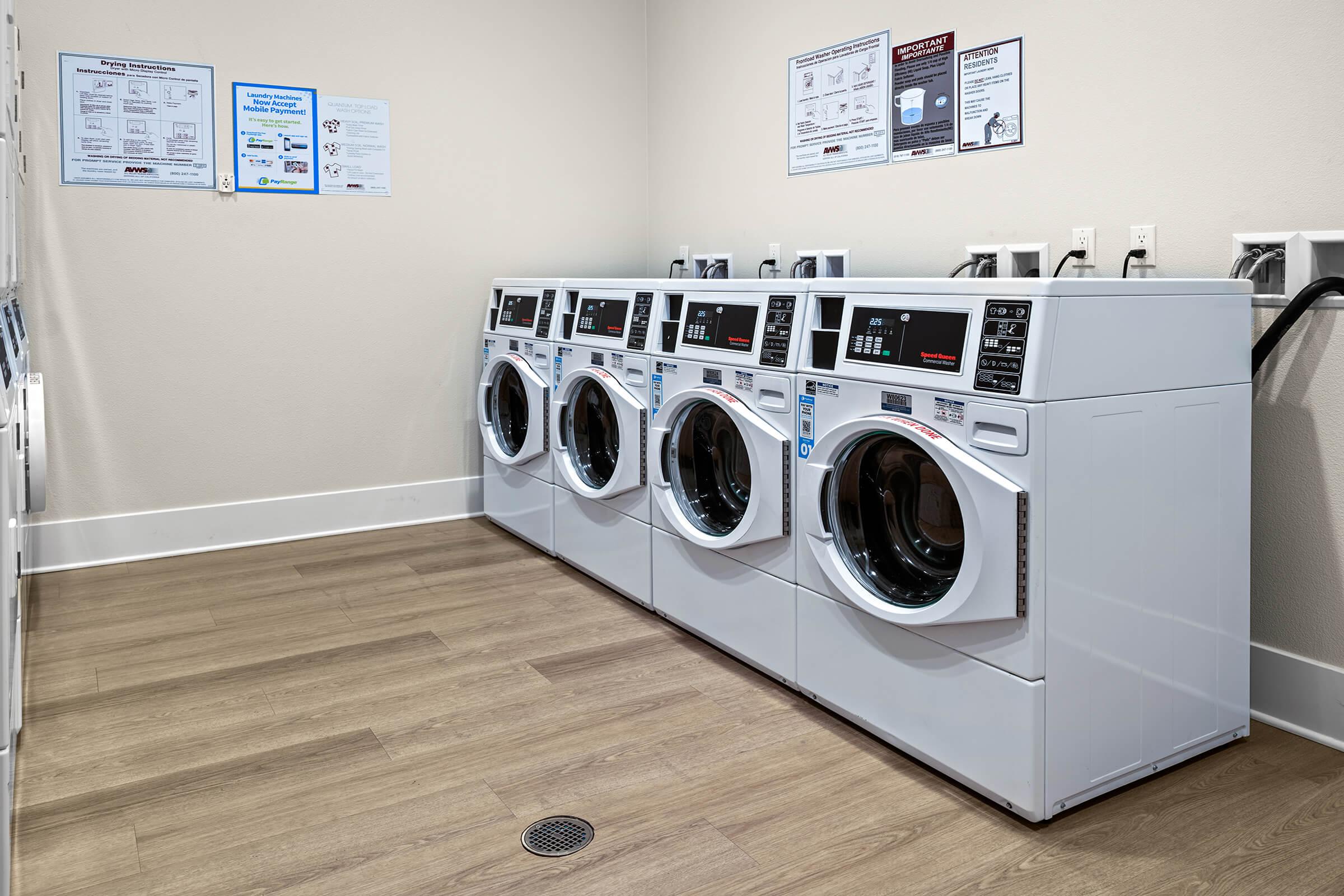 A laundry room featuring rows of washing machines and dryers. 