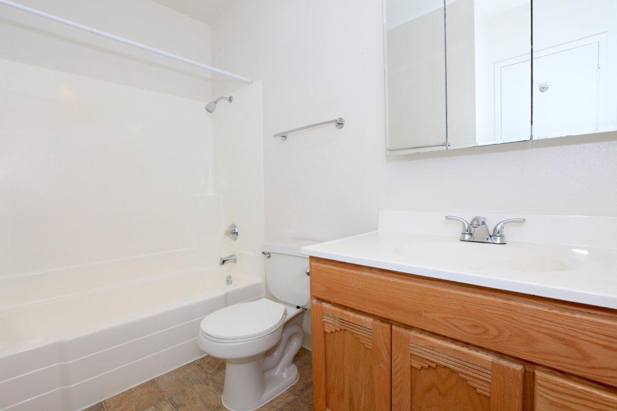 a white tub sitting next to a sink