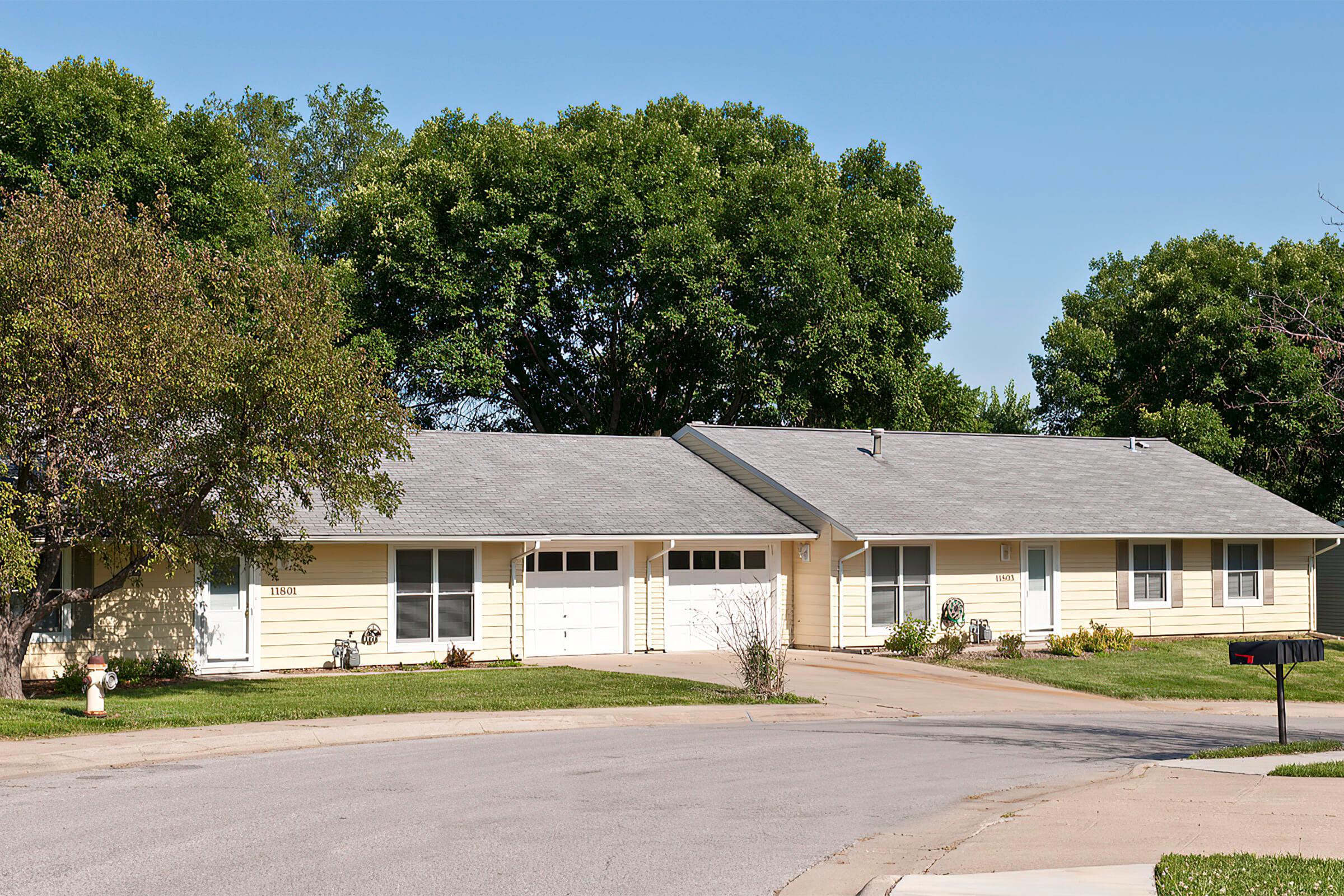 a tree in front of a house