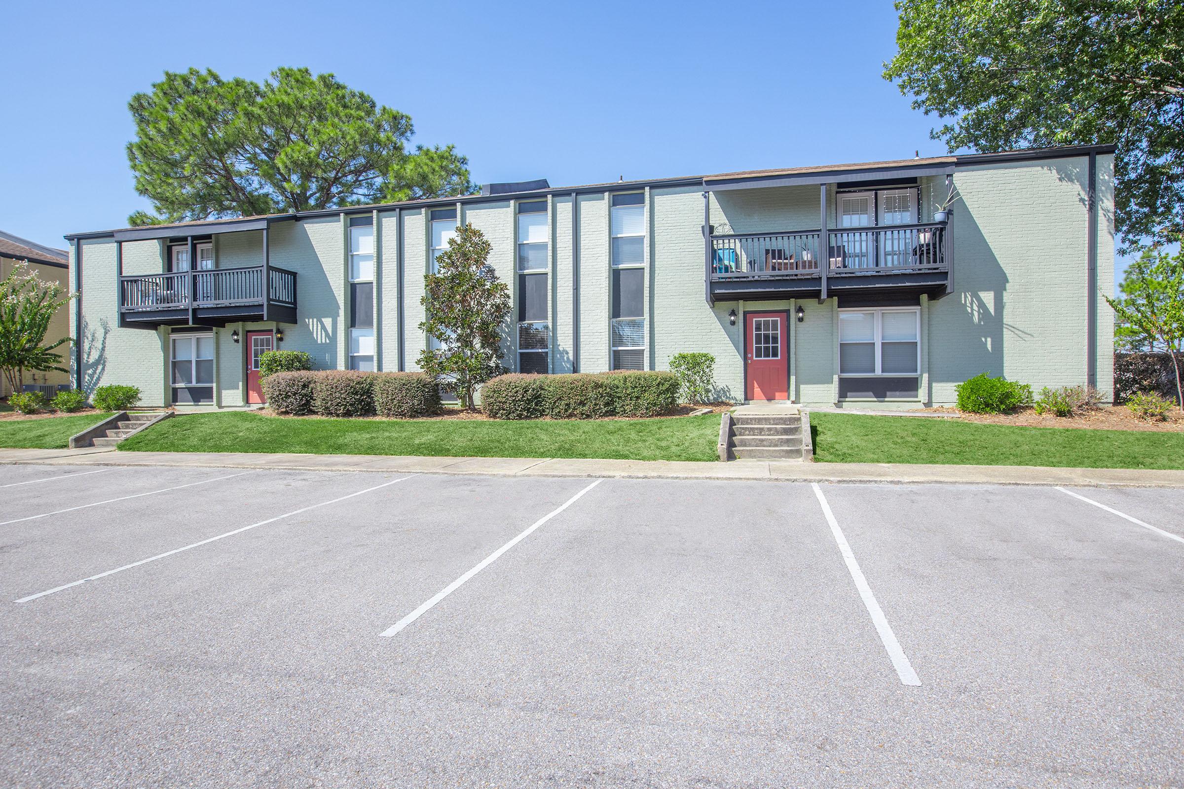 an empty parking lot in front of a house