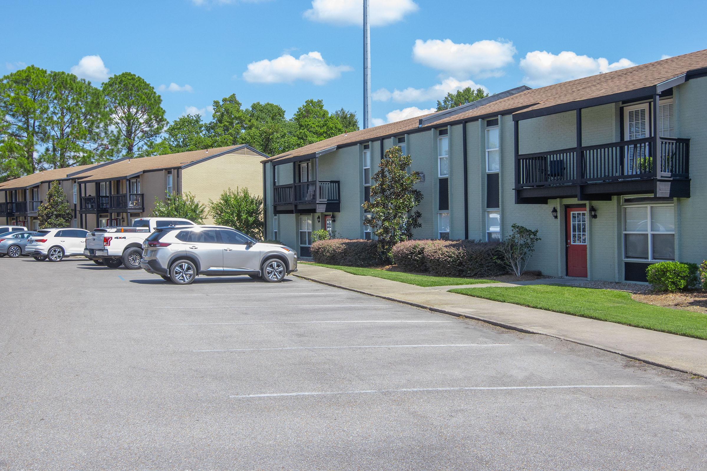 a car parked in a parking lot in front of a house