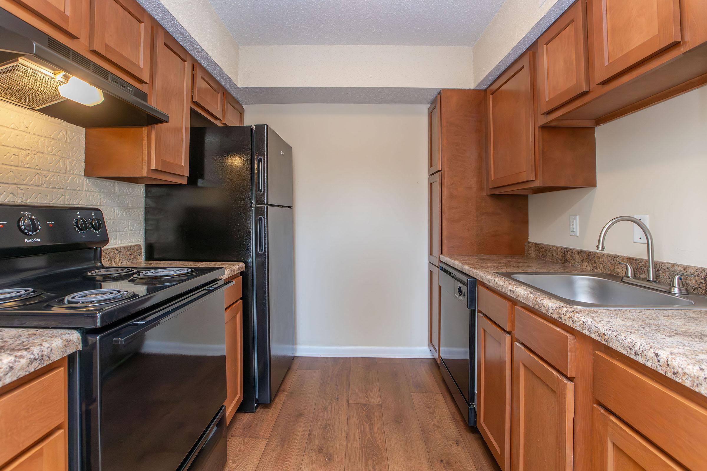 a kitchen with stainless steel appliances and wooden cabinets