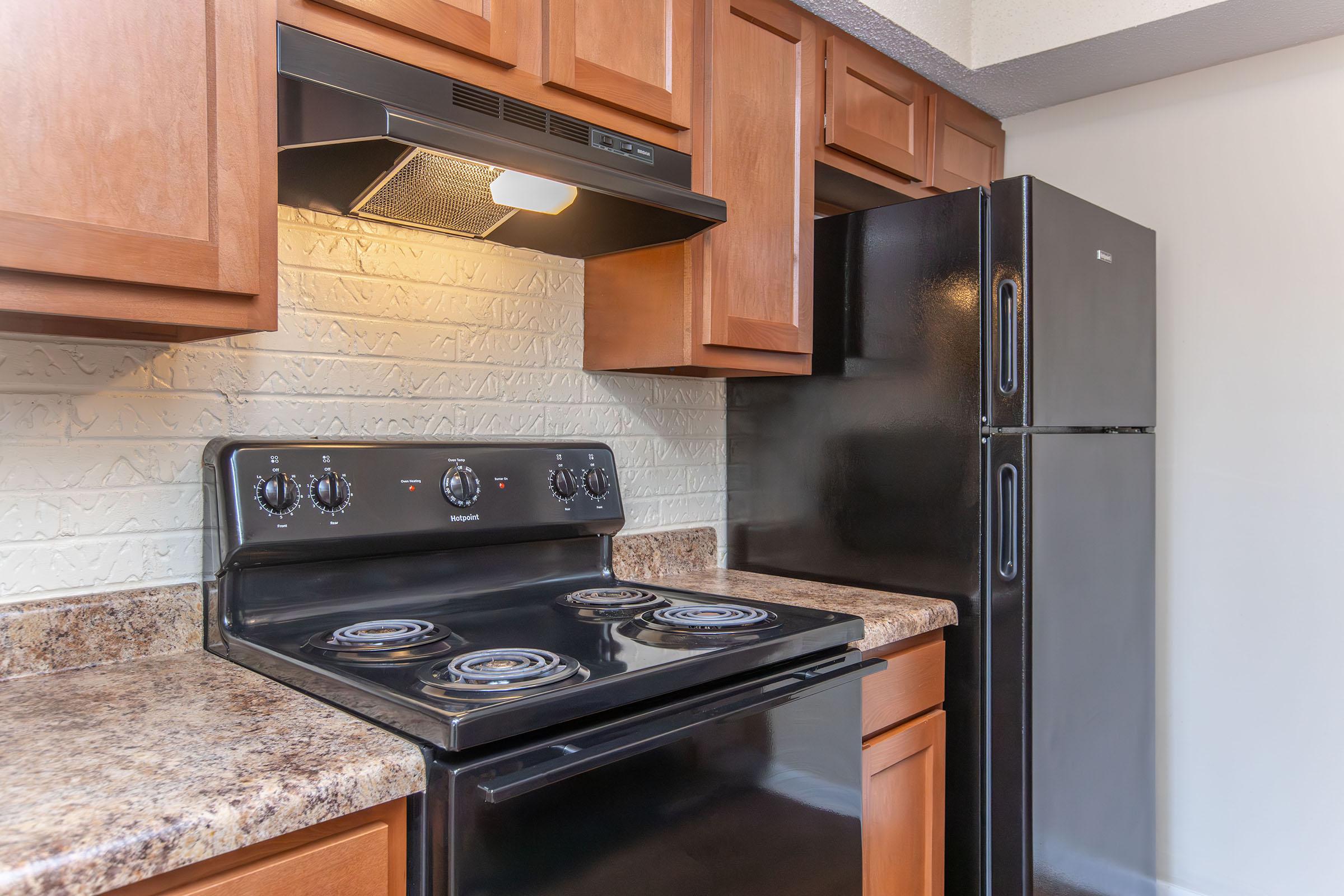 a stove top oven sitting inside of a kitchen