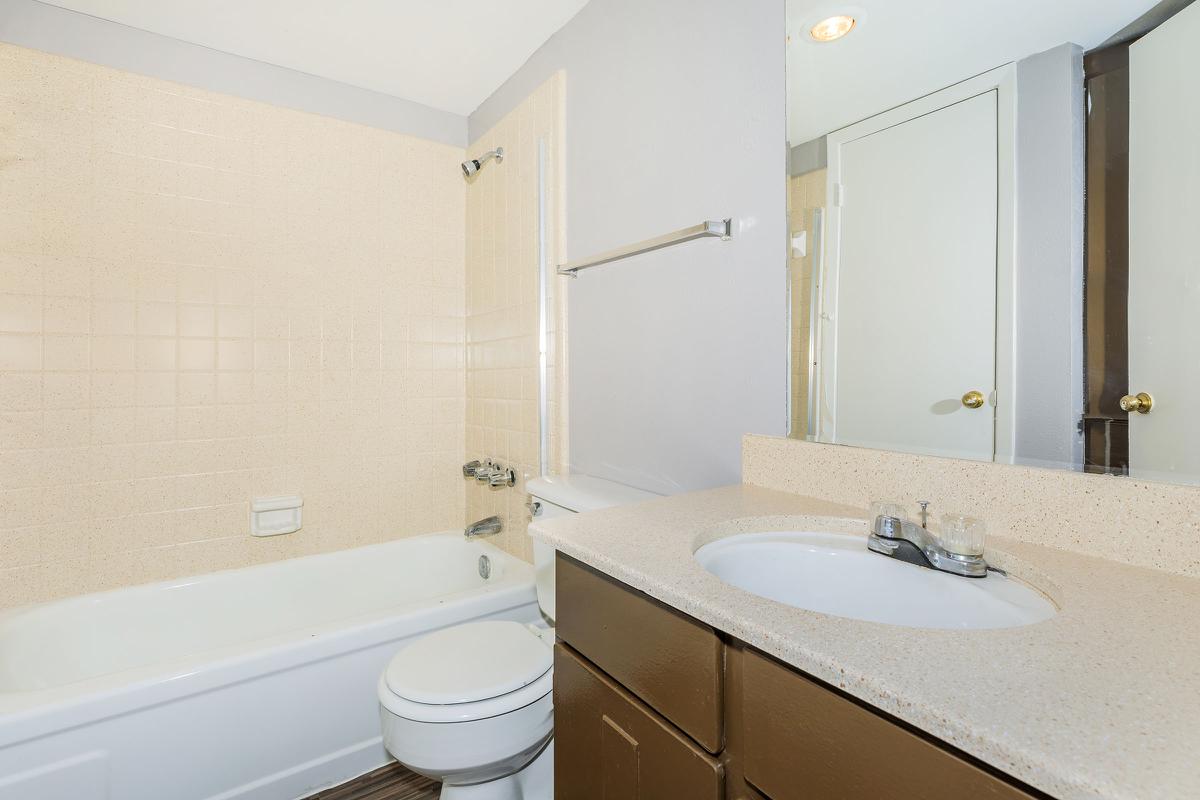 a large white tub sitting next to a sink