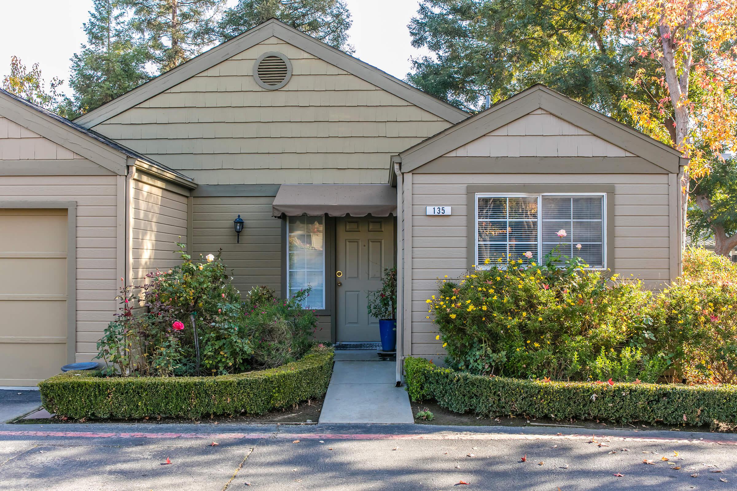 a house with bushes in front of a building