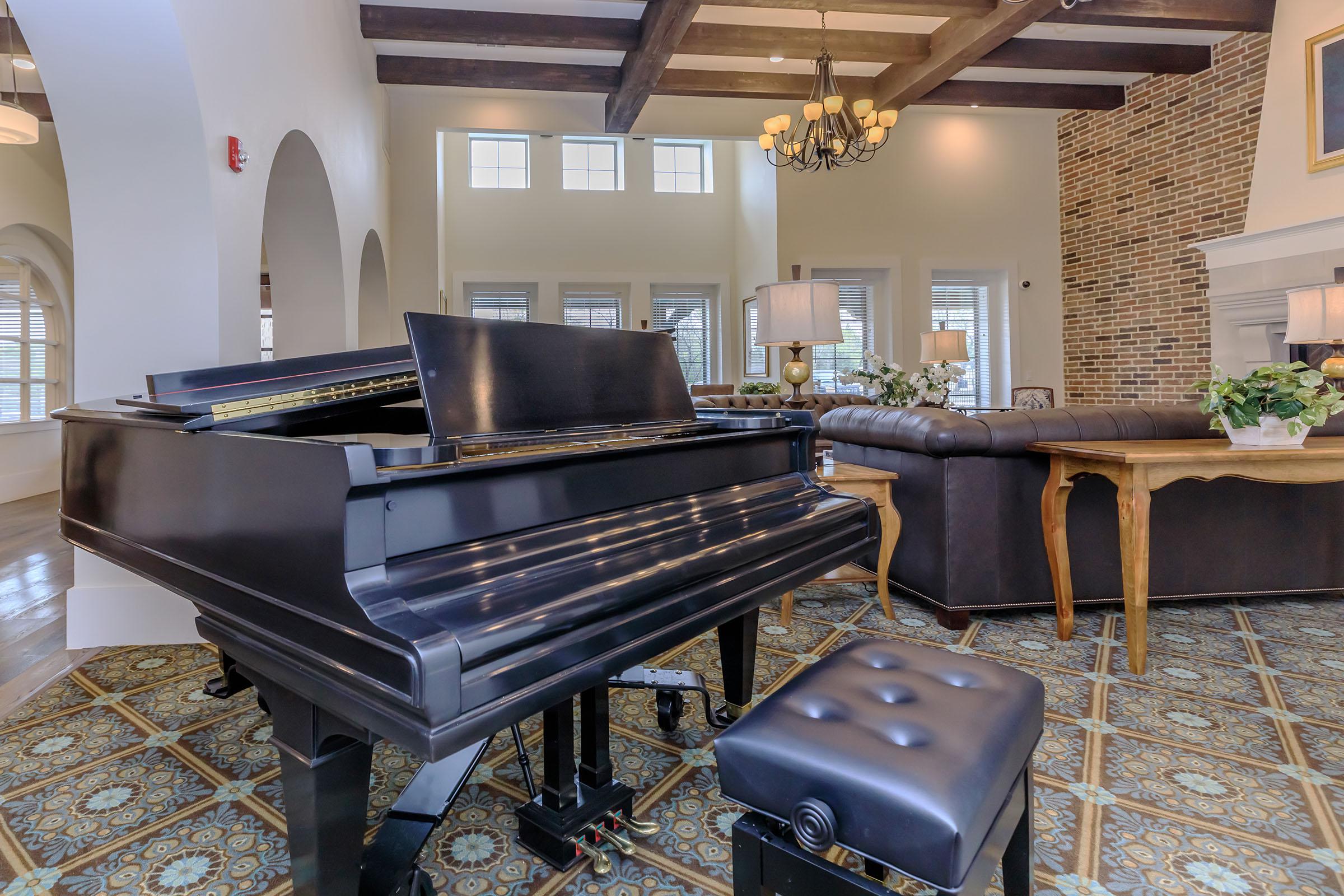 a living room filled with furniture and a piano