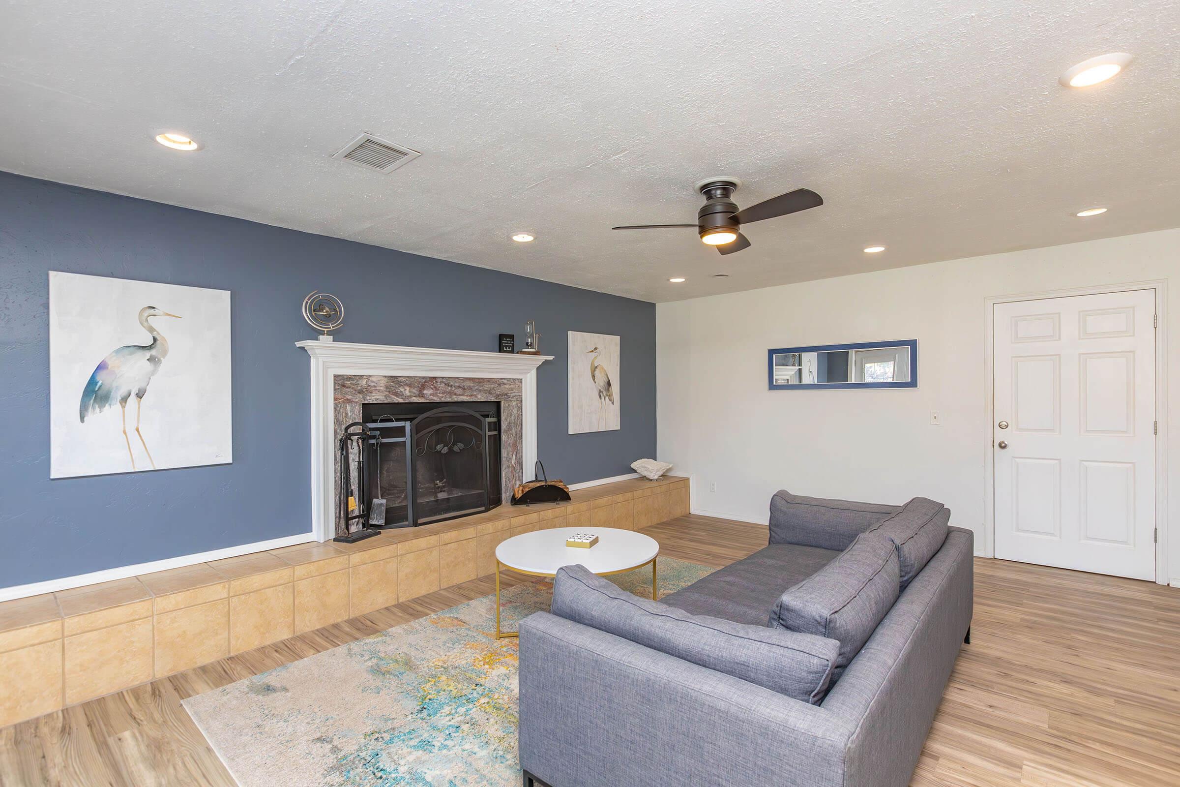 a living room filled with furniture and a fireplace